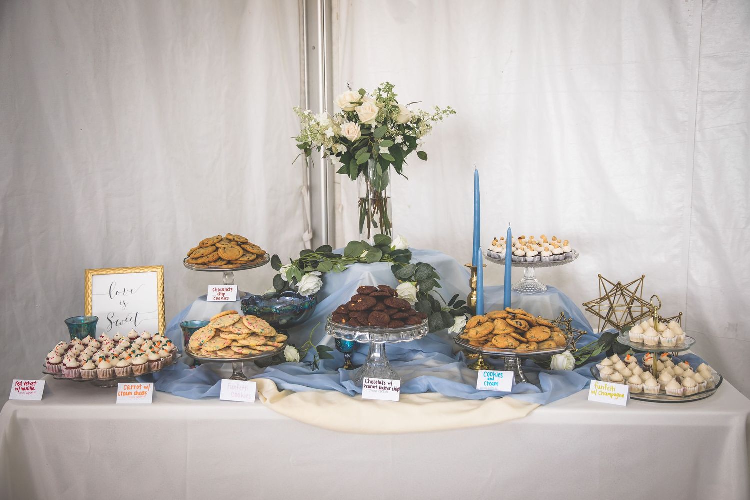 Elegant dessert table display with various pies and pastries at a wedding reception.