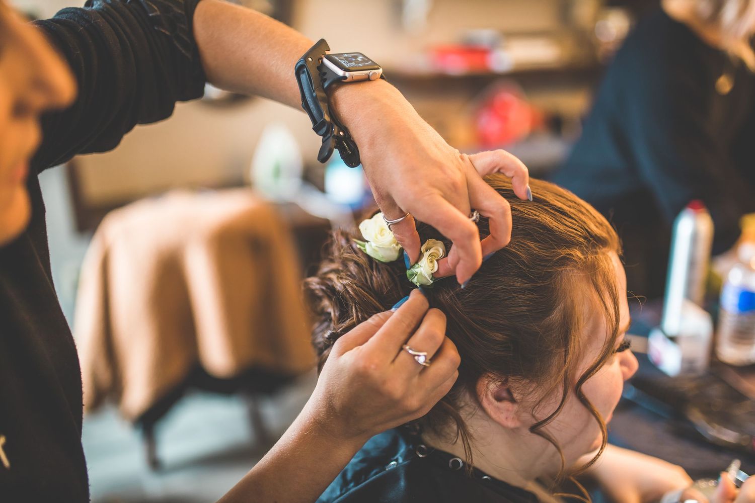 Hair styling session in progress with professional tools and equipment.