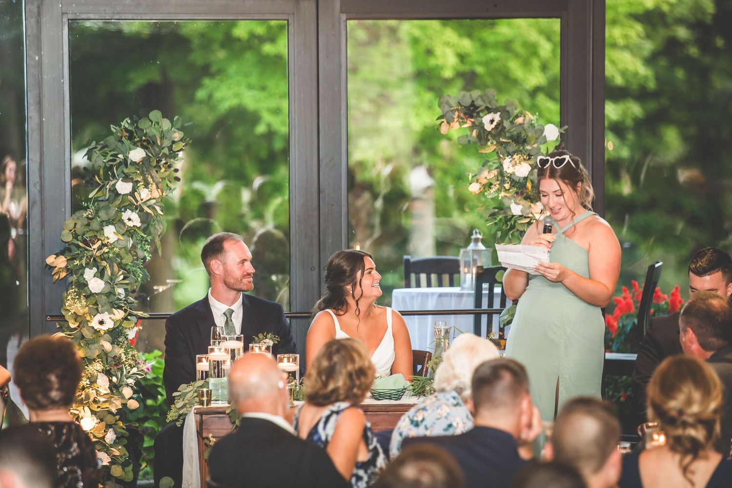 Natural light streams through large windows at an elegant wedding reception venue.