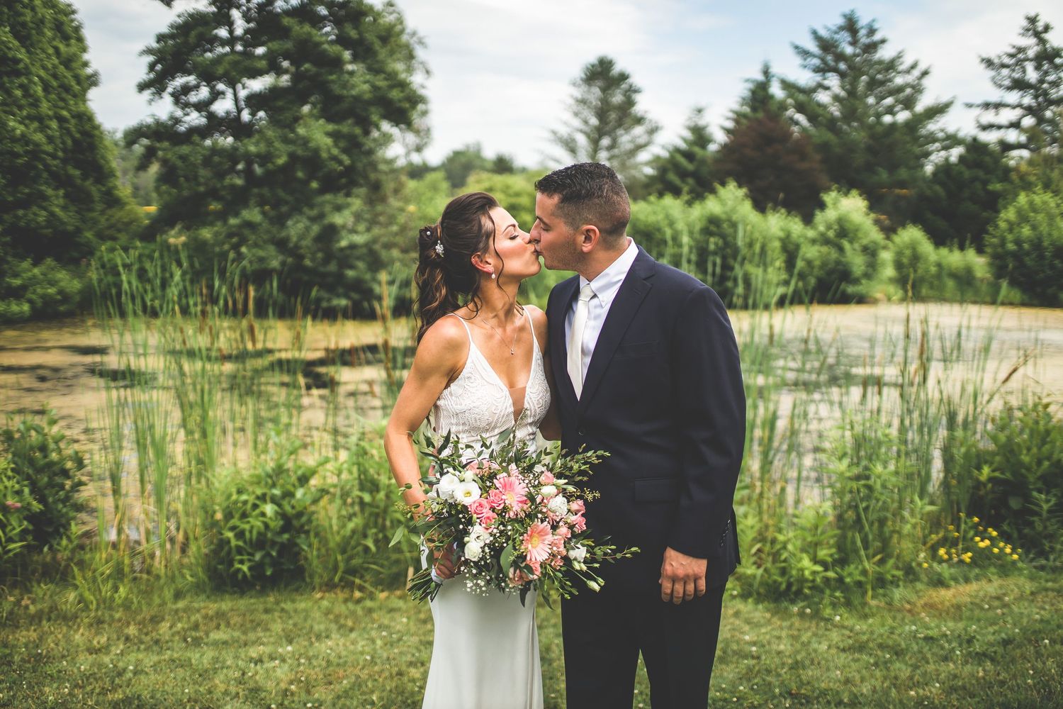 Romantic outdoor engagement photos in field of tall grass and wildflowers.