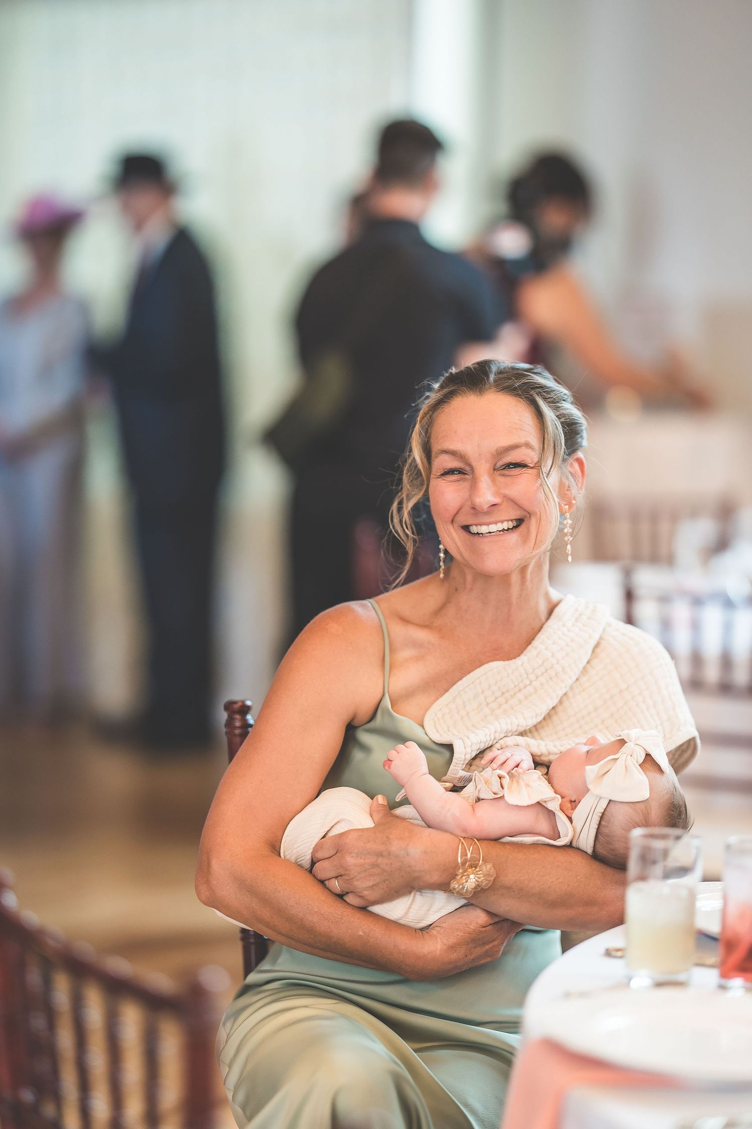 A guest enjoys a heartfelt moment of laughter during a wedding reception.