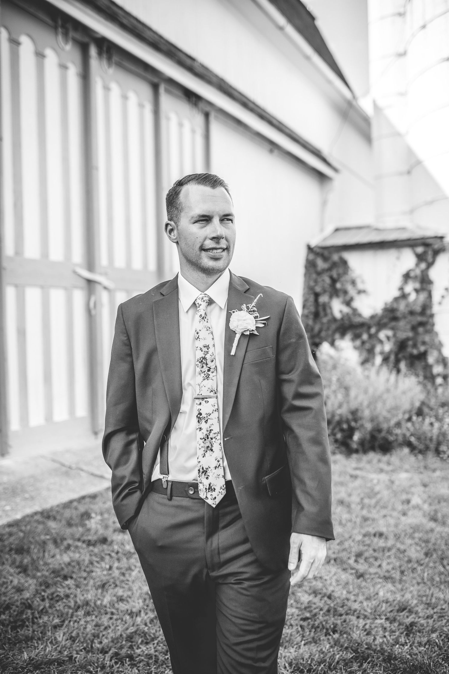 Black and white portraits of groomsmen in suits against architectural background.