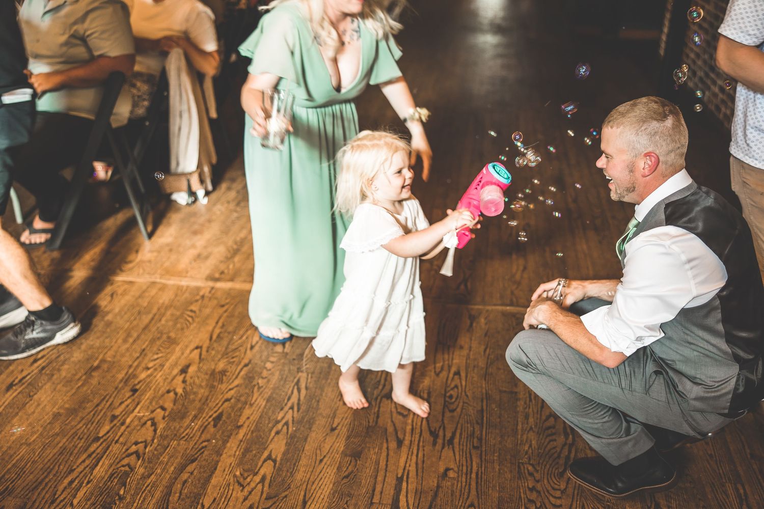 Wedding reception dance floor with guests in casual attire enjoying the celebration.