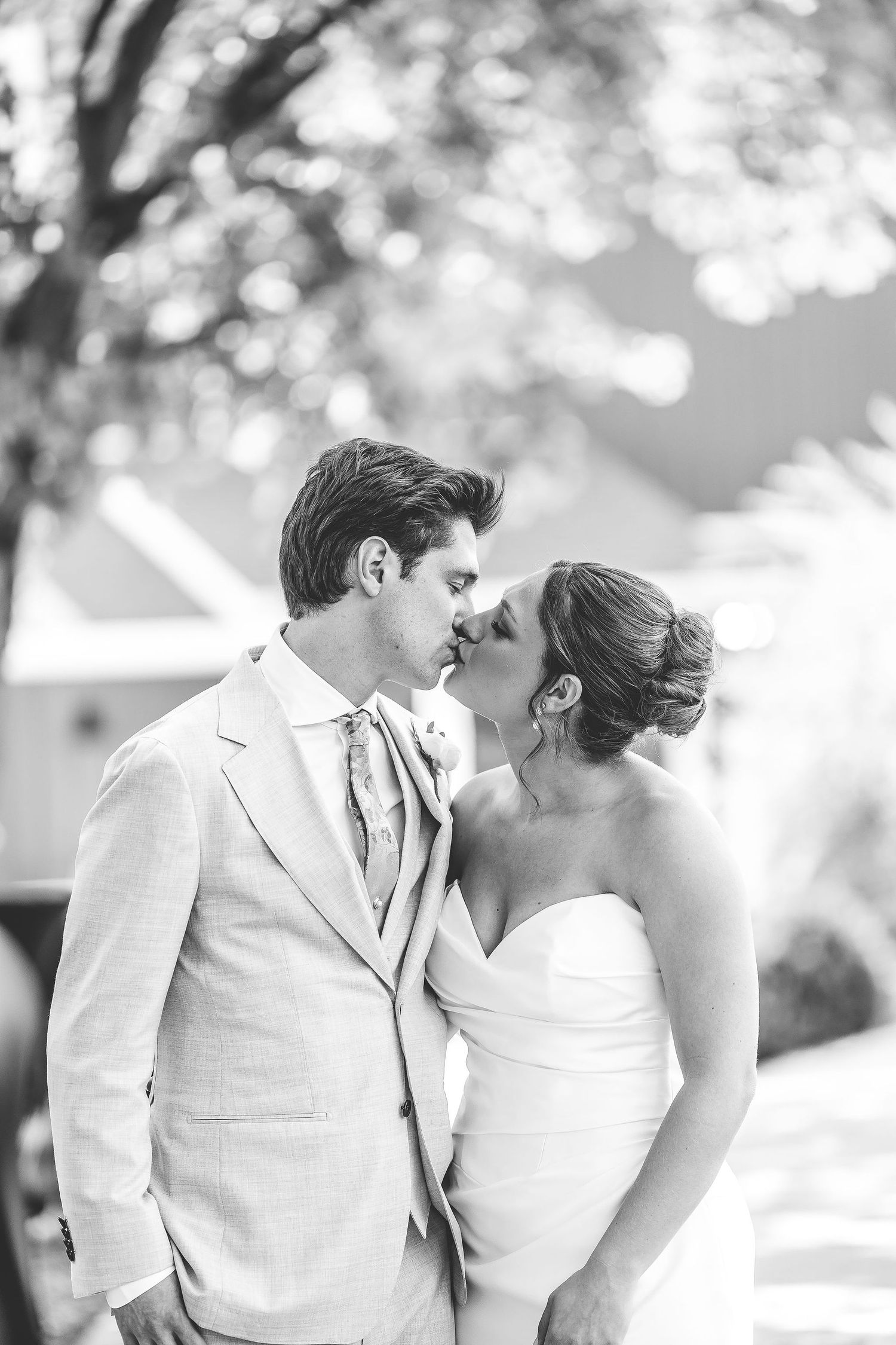 Black and white wedding portraits showing intimate moments between newlyweds in a garden setting.