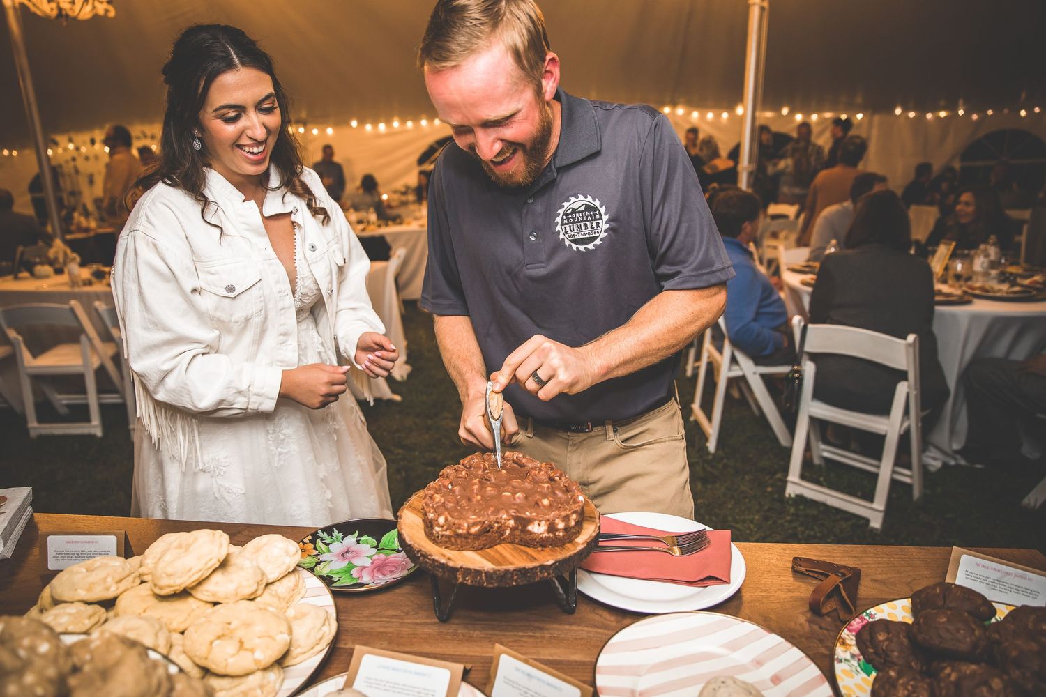 Guests enjoying desserts and treats at an elegantly lit indoor reception.