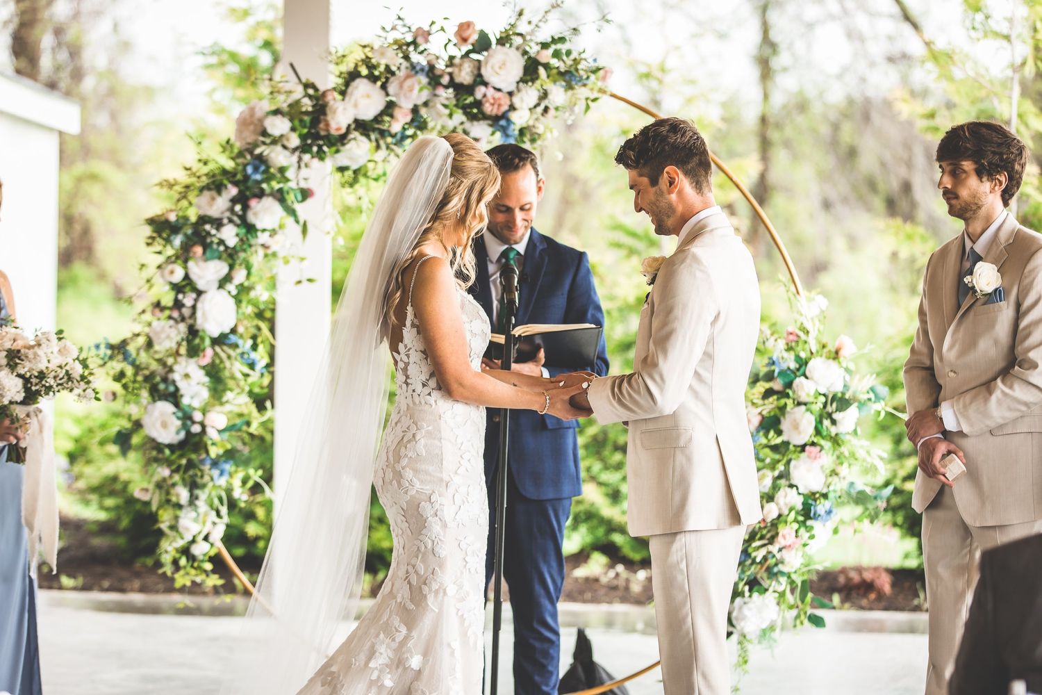 Wedding ceremony in progress with floral decorations and natural lighting.
