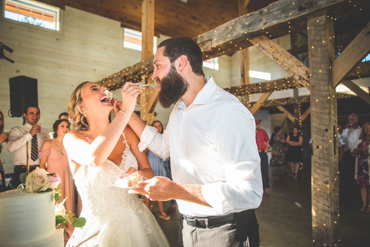 Guests dancing and celebrating at rustic outdoor wedding reception.