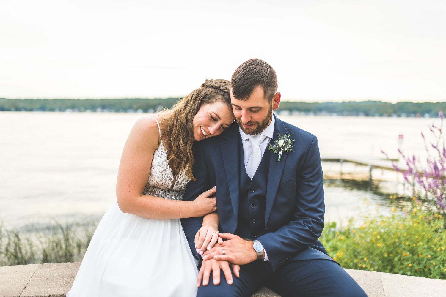 Waterfront wedding photos with scenic lake and dock backdrop.
