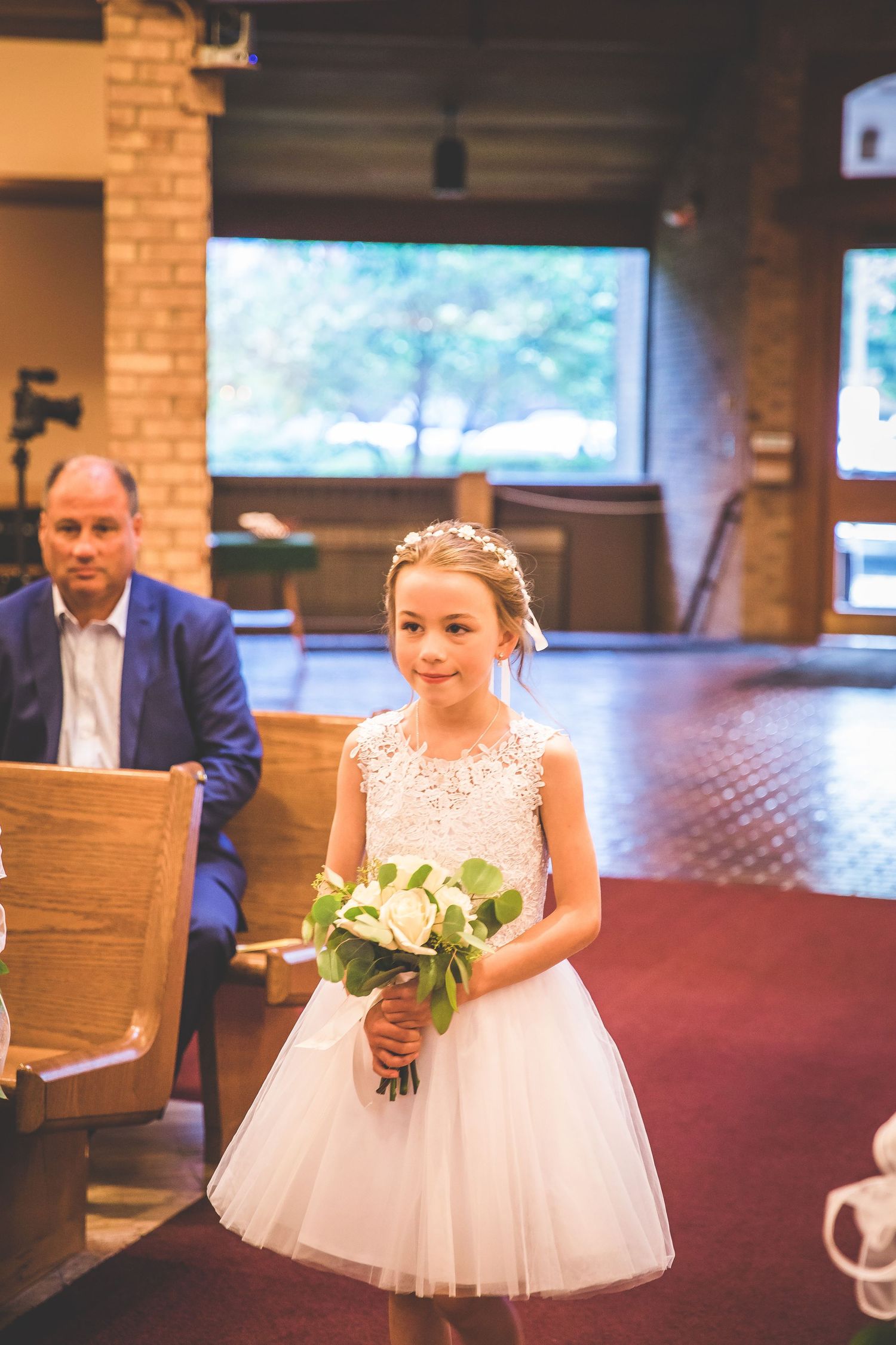 Wedding celebration in a rustic venue with exposed brick walls and natural lighting.