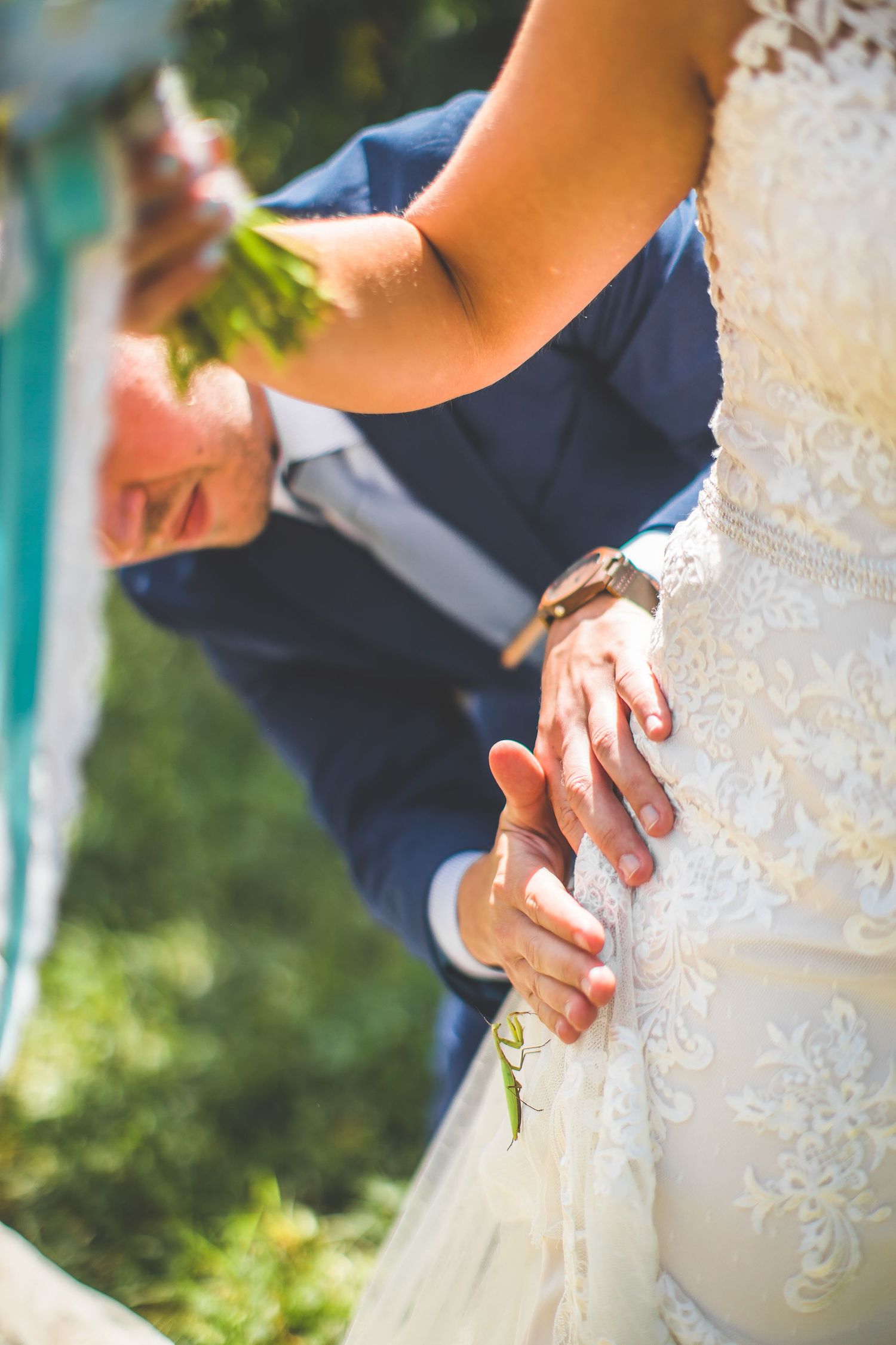 Detail shot of intricate lace wedding dress with delicate beading and embroidery.