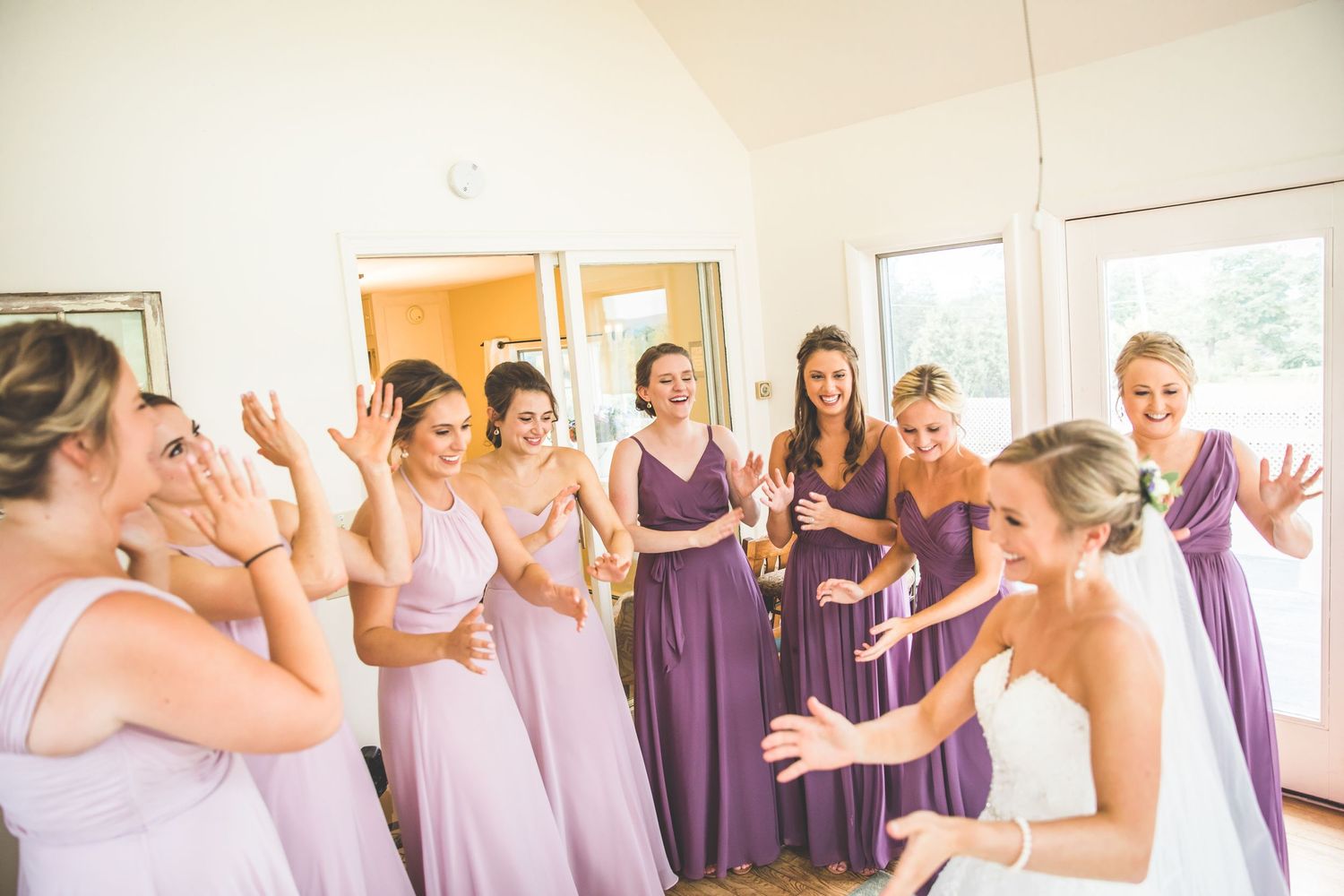 Candid moments captured during wedding day preparations in a bright indoor setting.
