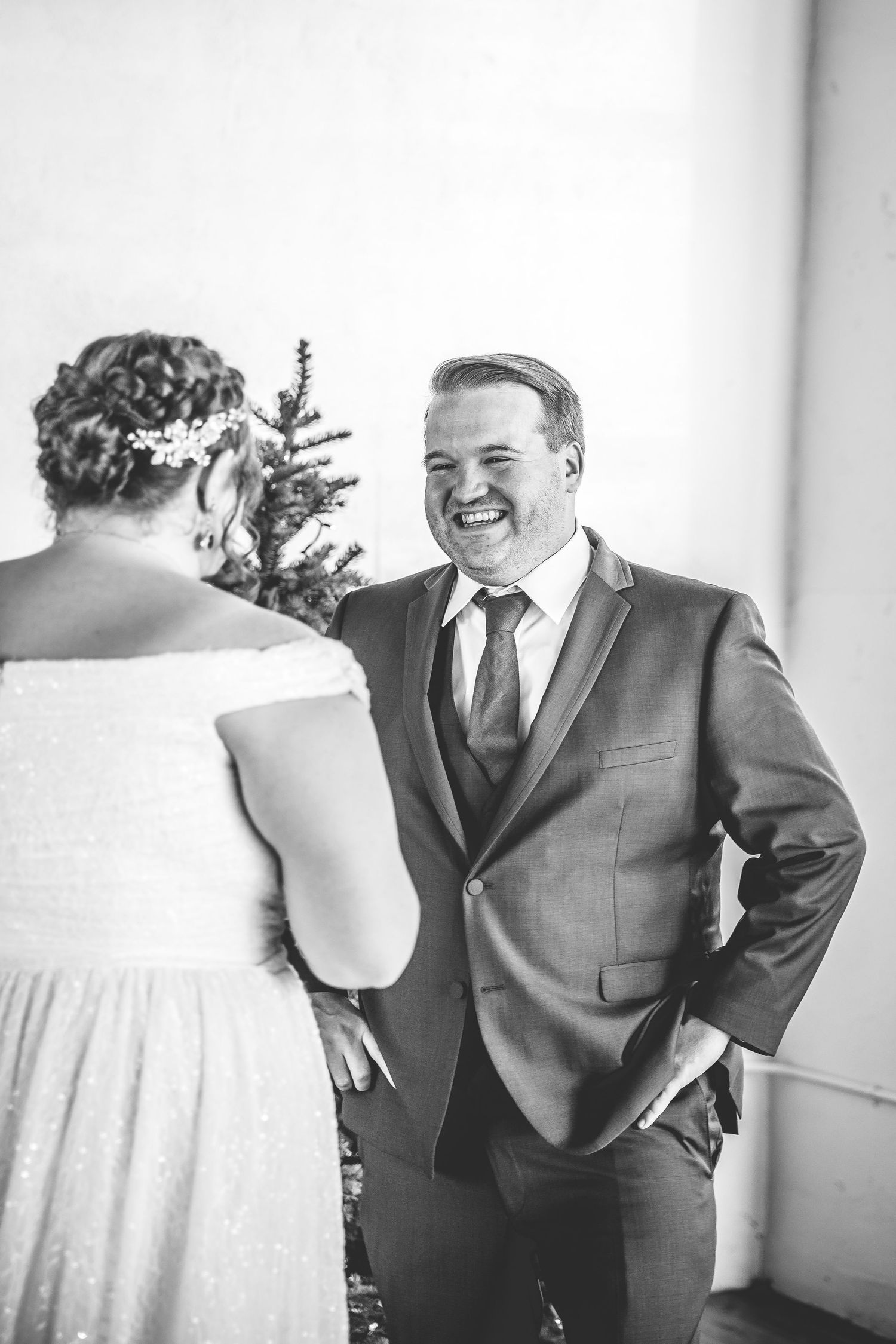Black and white candid moment between couple during winter wedding ceremony.