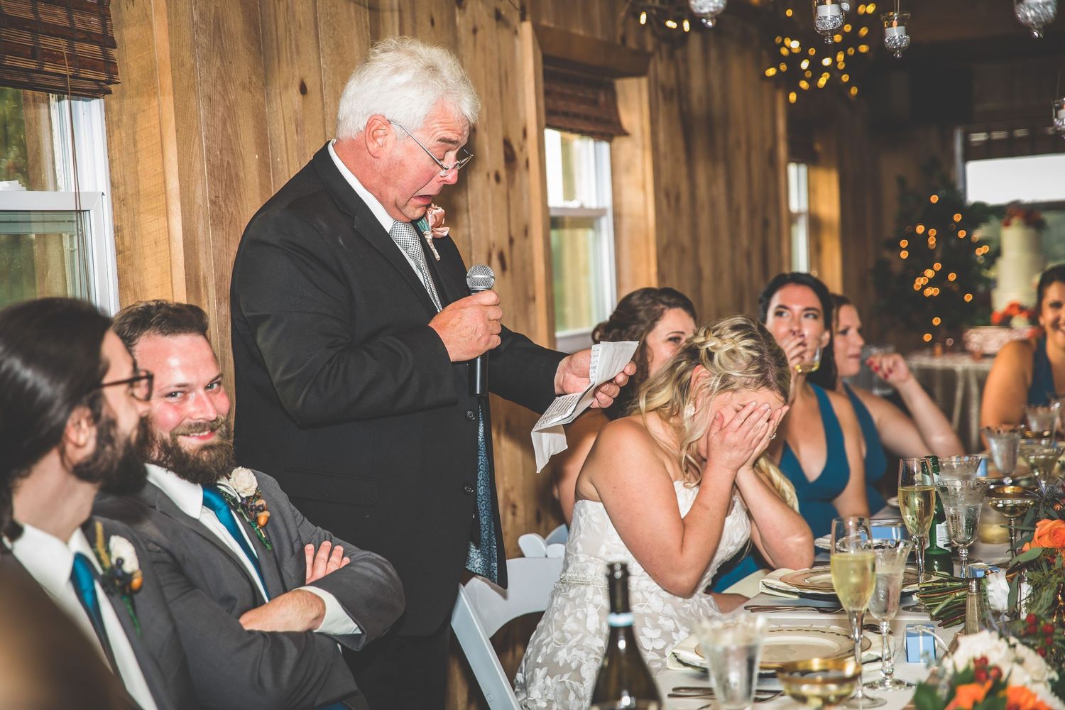 Candid reception moments with guests dining at rustic wooden tables.