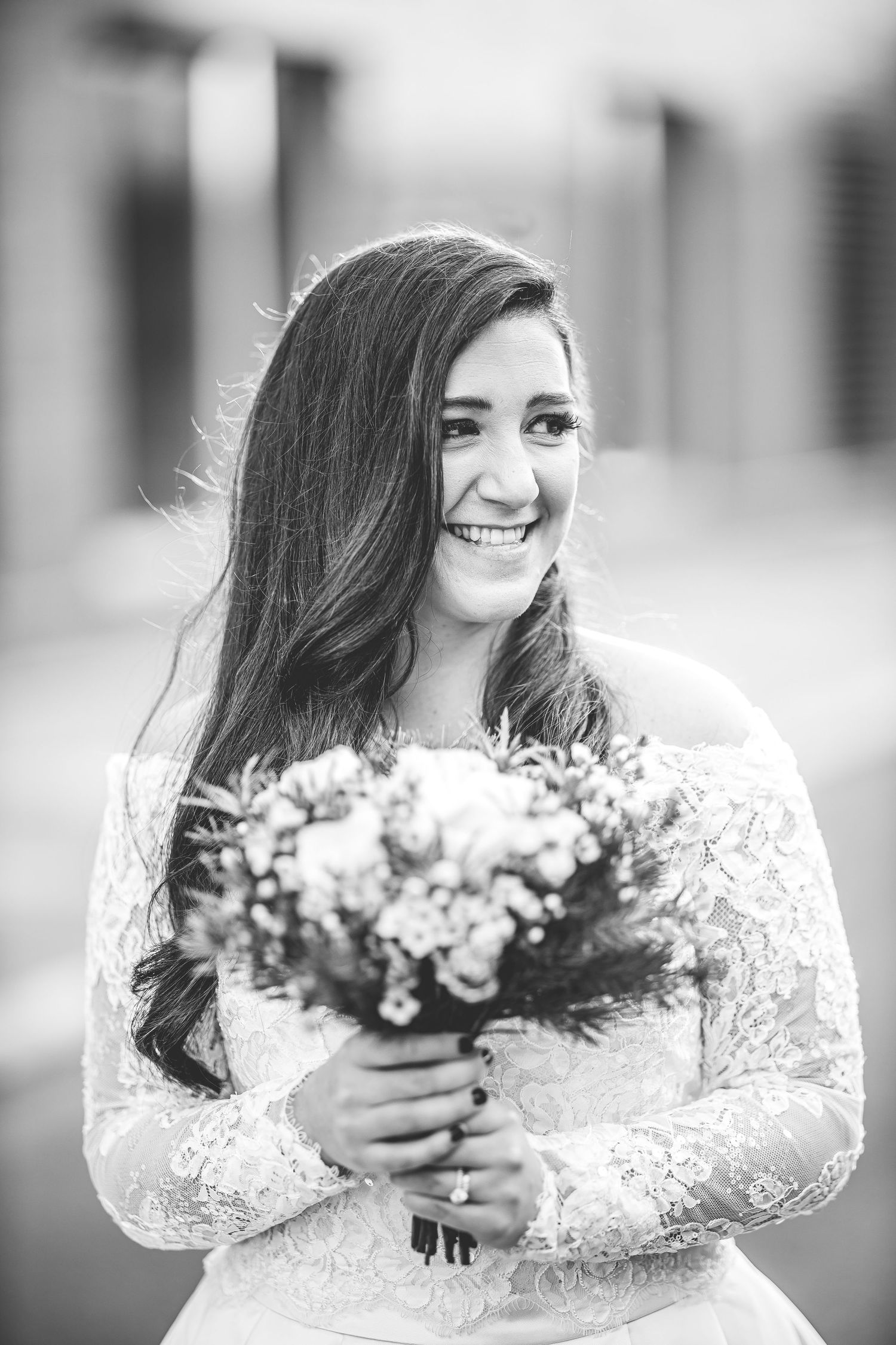 Black and white bridal portraits showing natural expressions with bouquet.