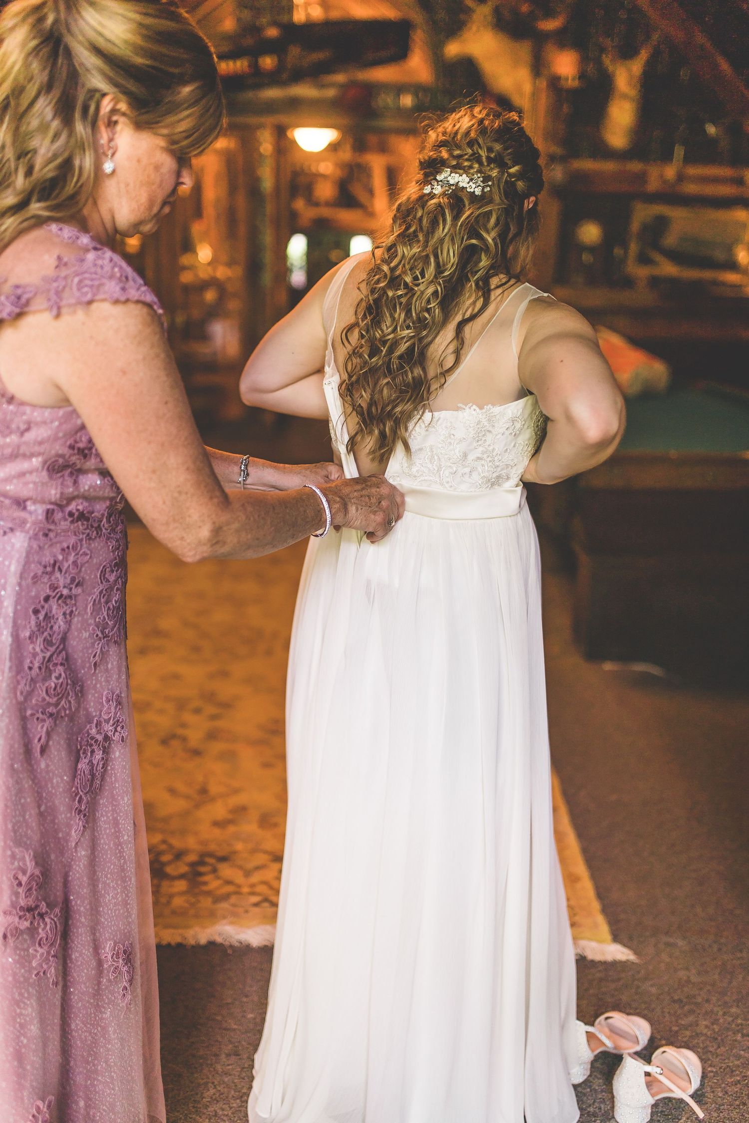 Wedding party members in purple and white dresses during an evening celebration.