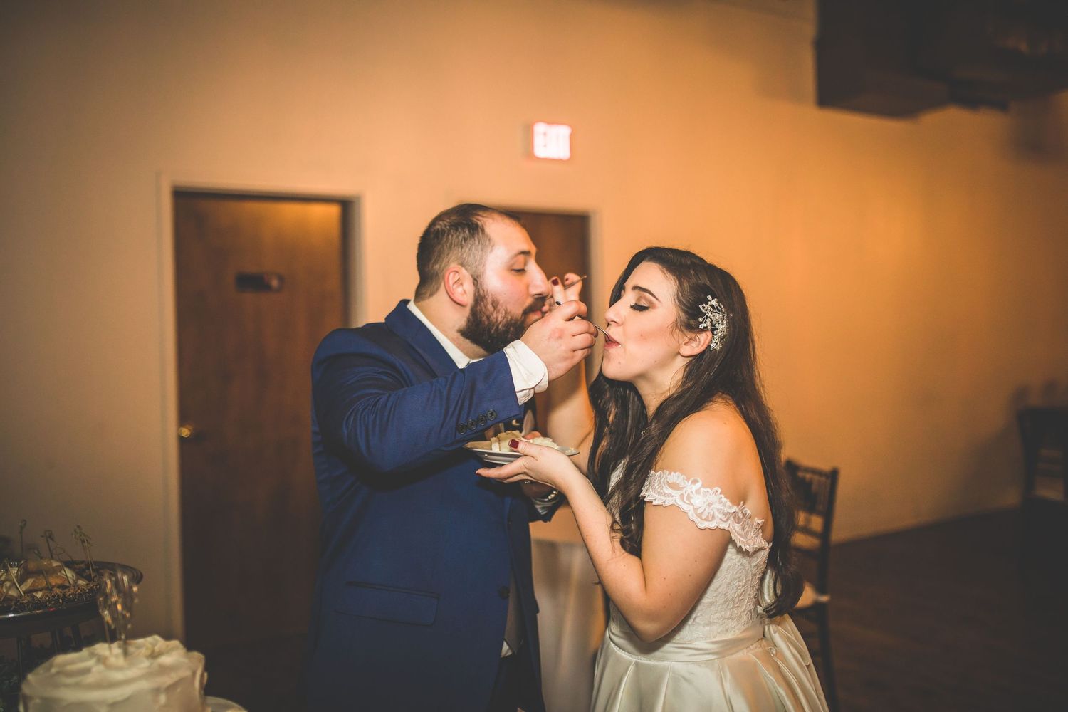 Intimate wedding reception moments captured in warm lighting with guests celebrating.