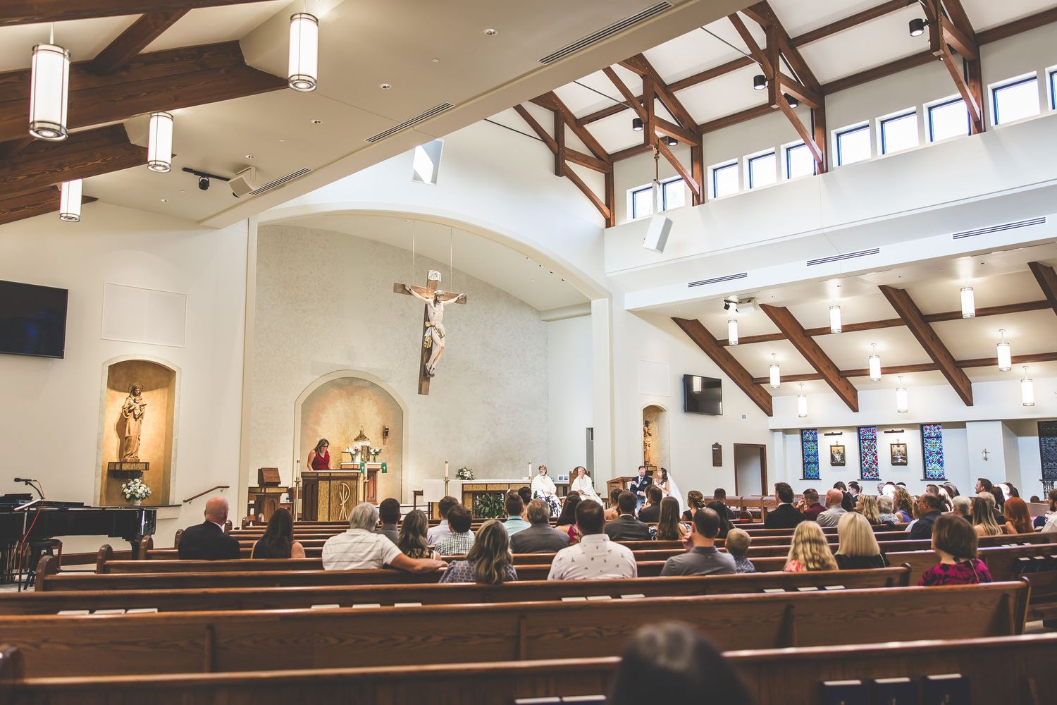 Panoramic view of a church sanctuary during a wedding ceremony with natural lighting.