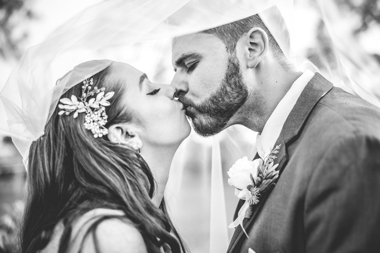Black and white wedding portraits showing tender moments between newlyweds.