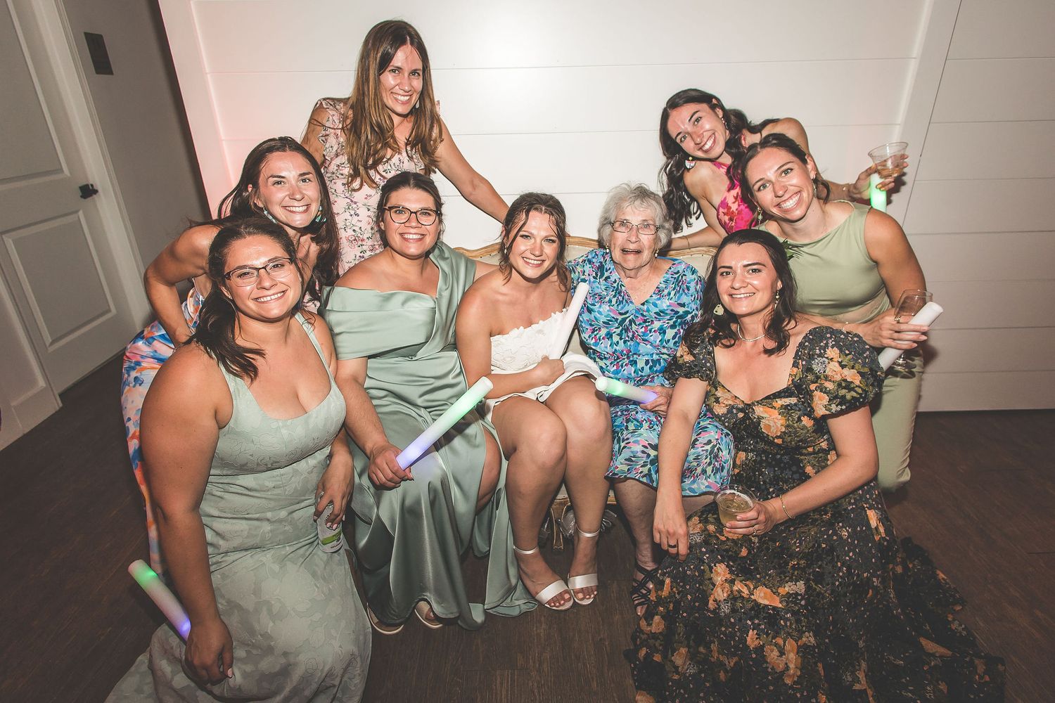 Wedding party poses together for a group photo in formal attire.