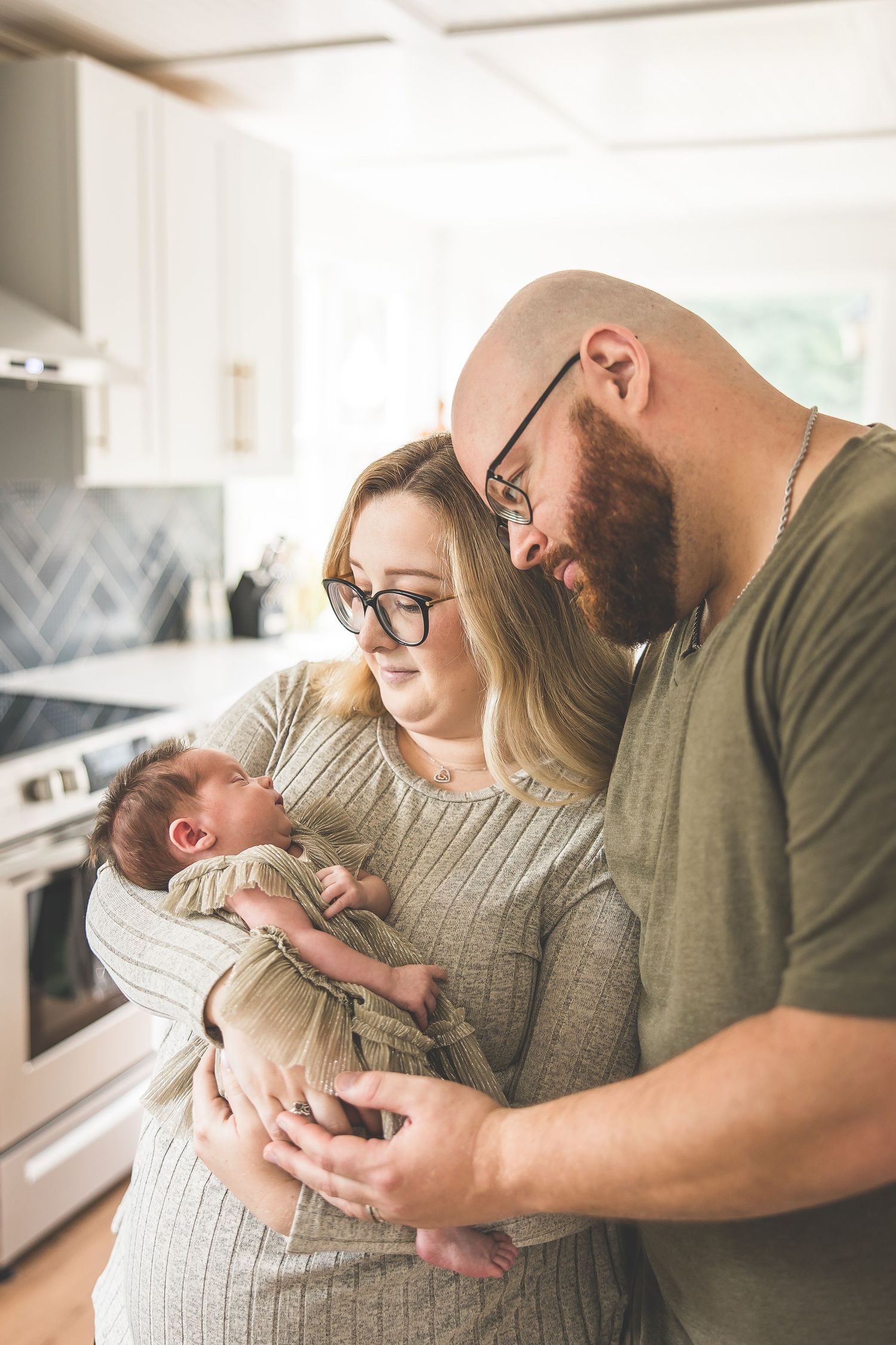 Family sharing intimate moment together in bright modern kitchen.