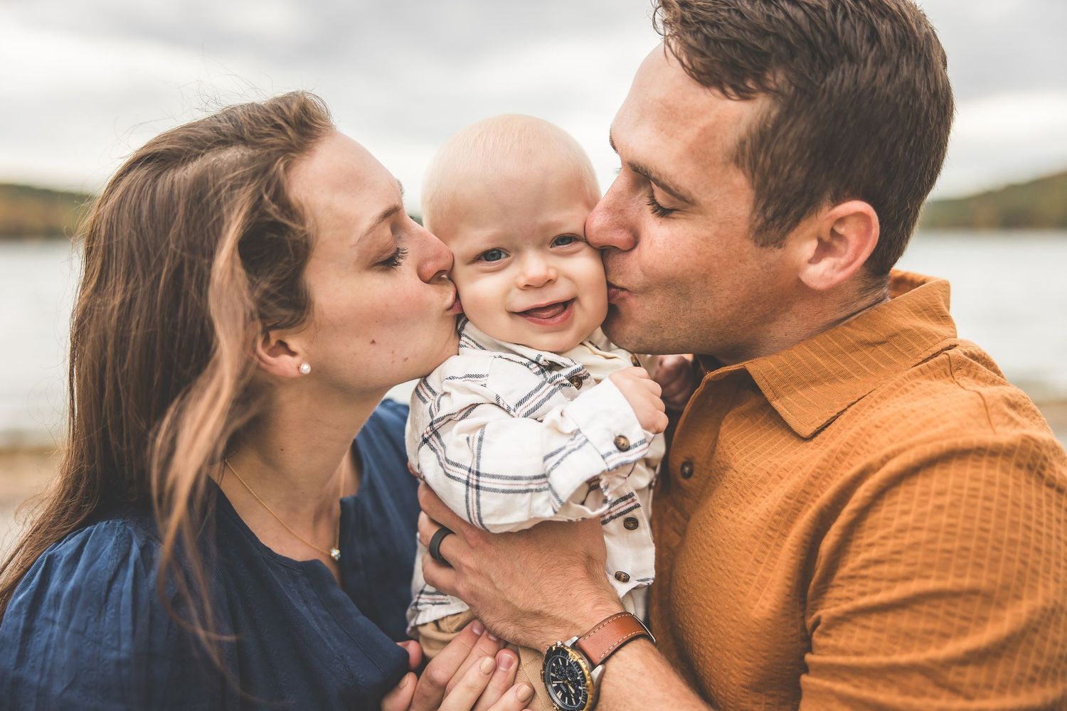 A sweet family moment captured in close-up during an outdoor photoshoot.