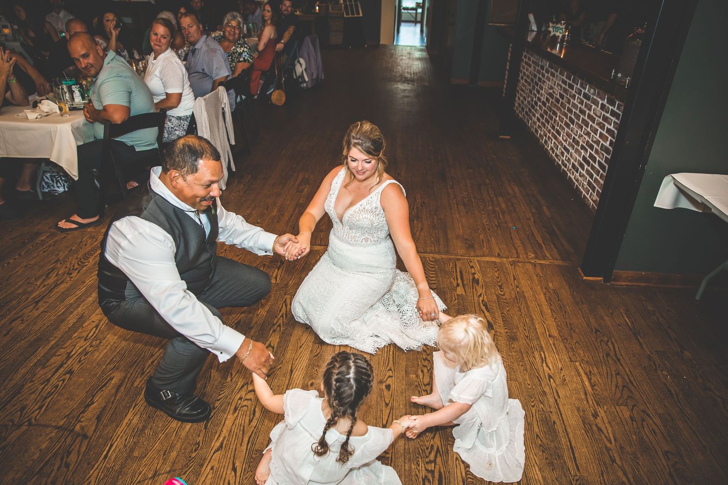 Bride and groom sharing a playful moment on the dance floor during their wedding reception.