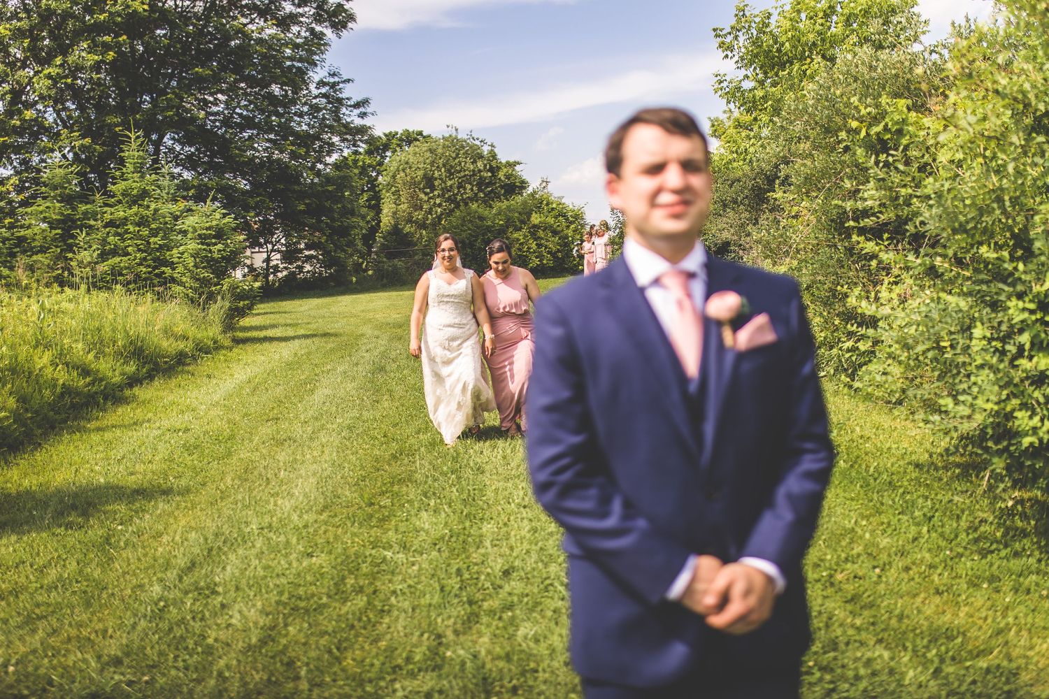 Wedding couple sharing intimate moments in a lush green outdoor setting.