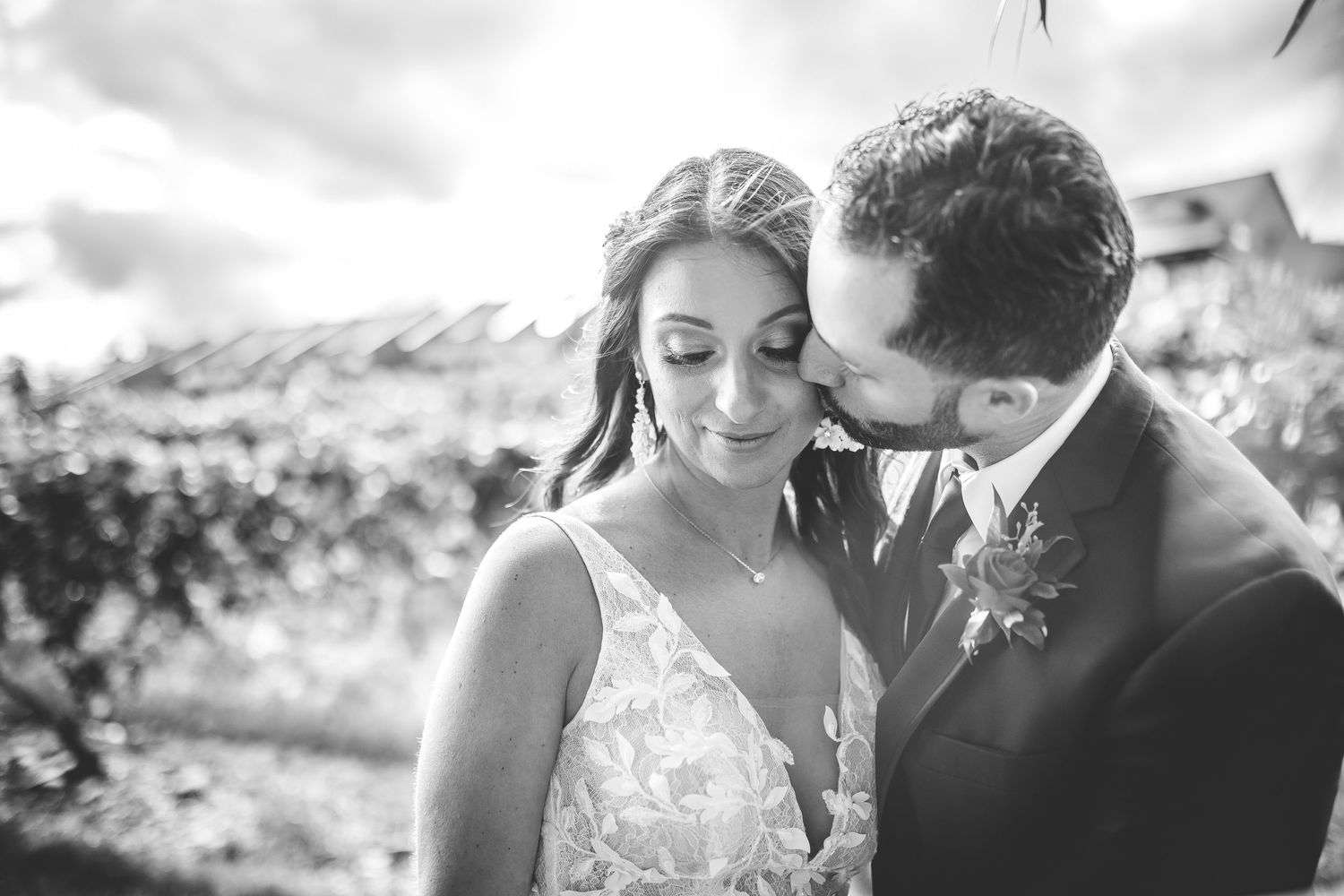 Intimate black and white wedding portraits under willow trees.