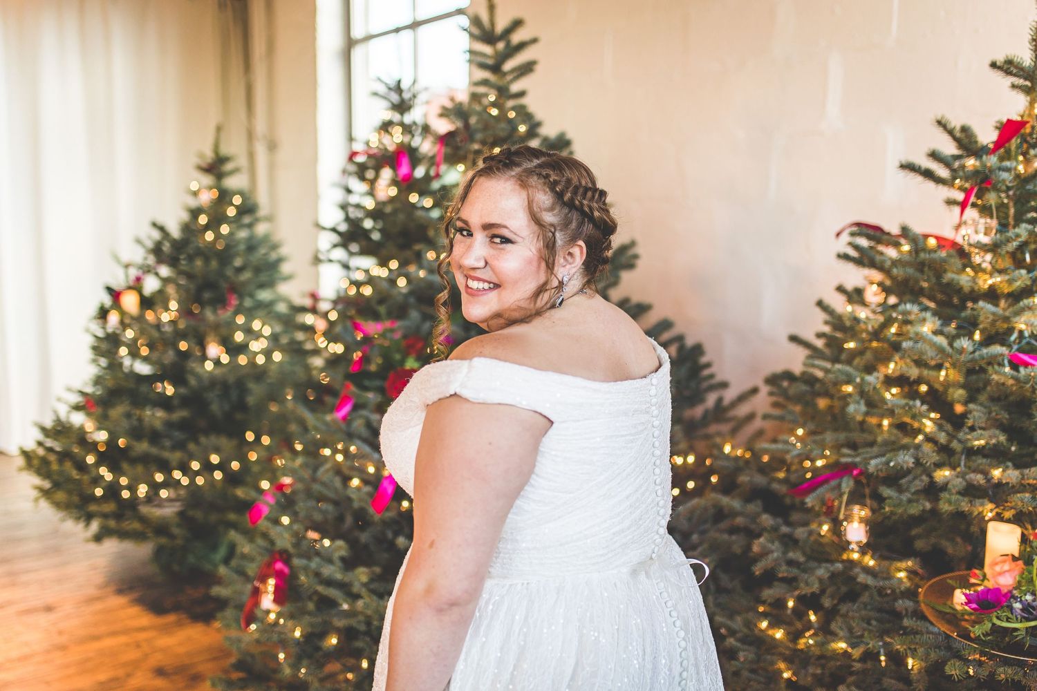 Wedding dress detail shots with festive Christmas trees in the background.