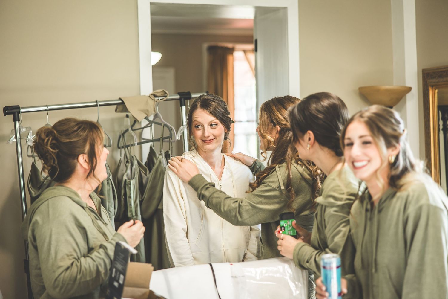 Group getting ready scene with matching outfits in a bright indoor space.
