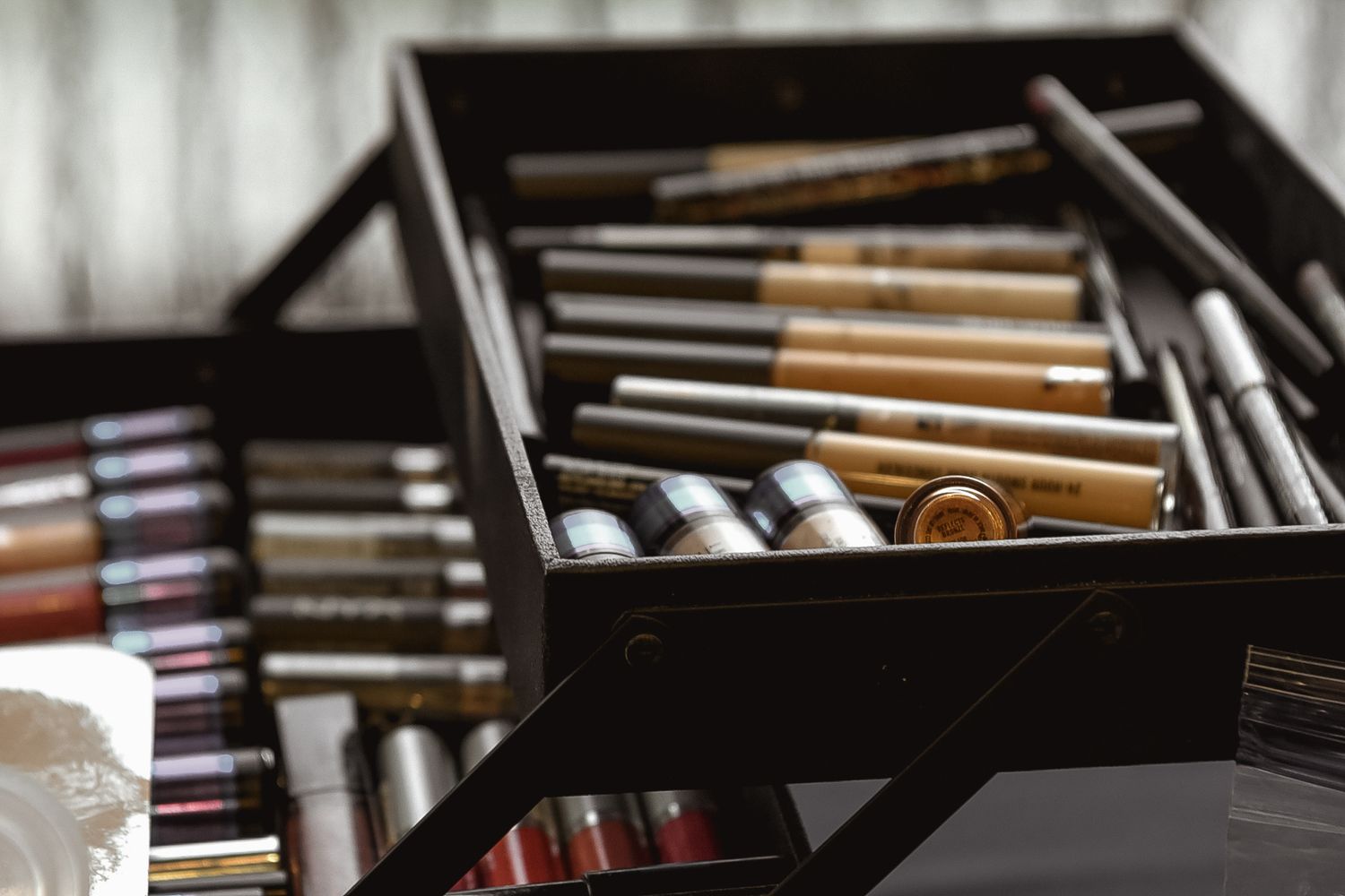 Close-up of organized makeup brushes and tools arranged in rows.