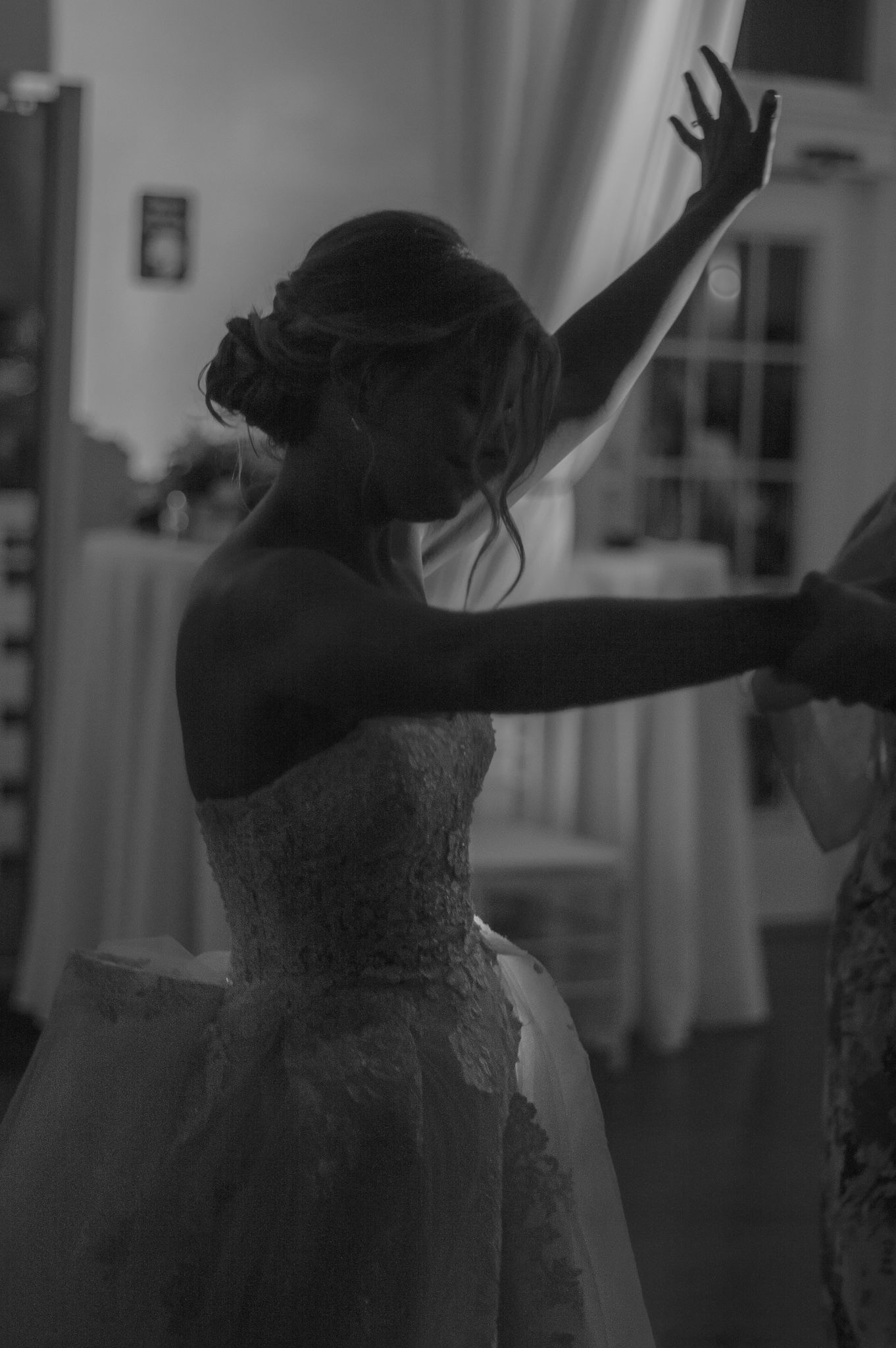 Silhouetted dancers in motion against a light background.