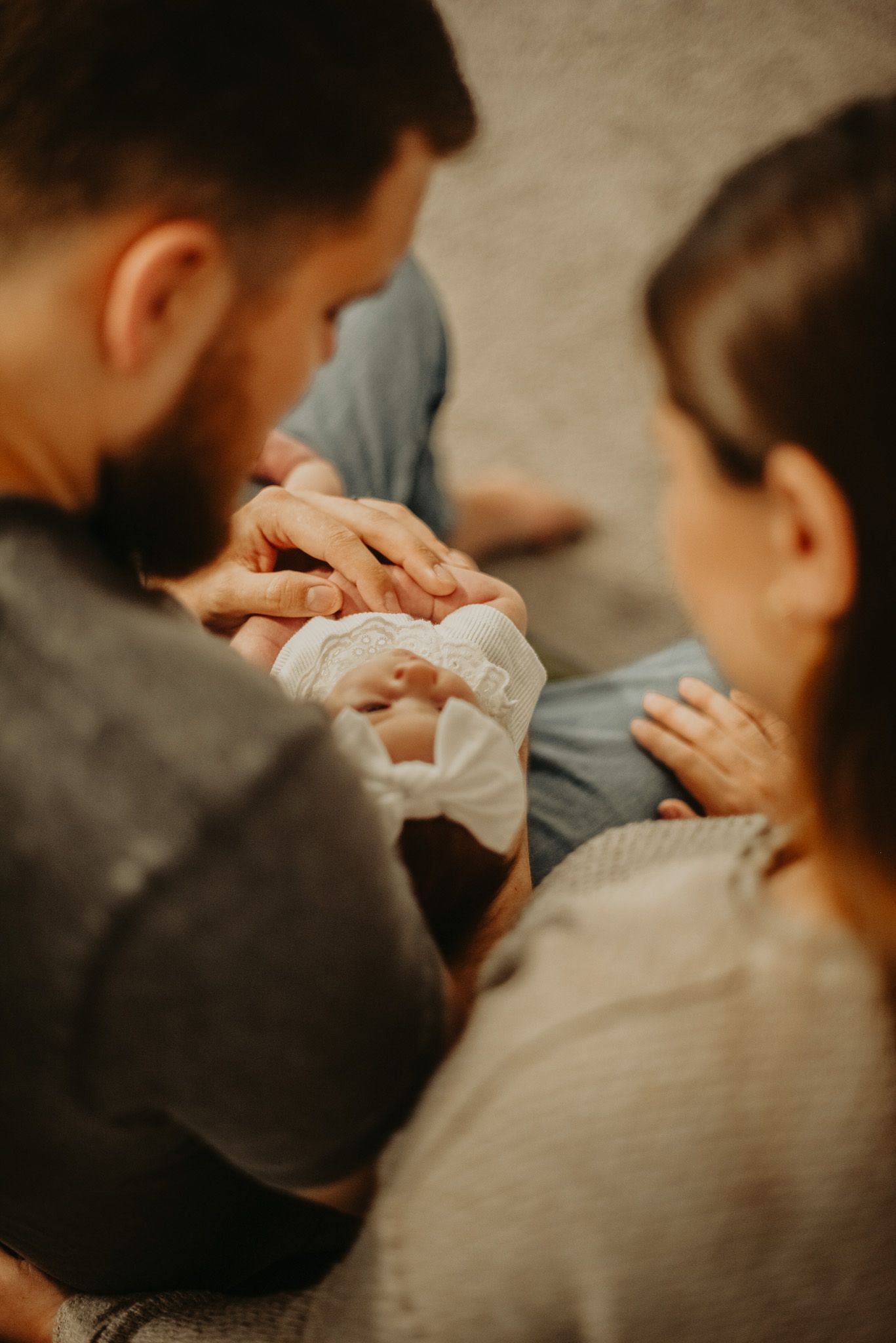 Close-up of gentle hands caressing in warm lighting.