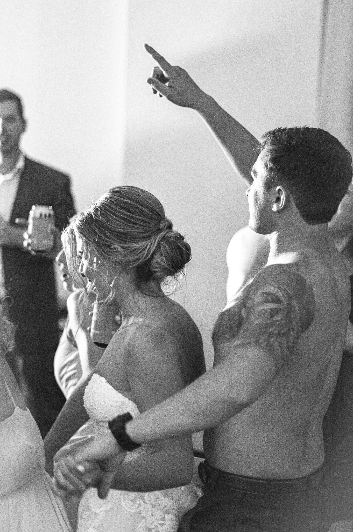 Black and white sequence of dancing figures at a wedding reception.