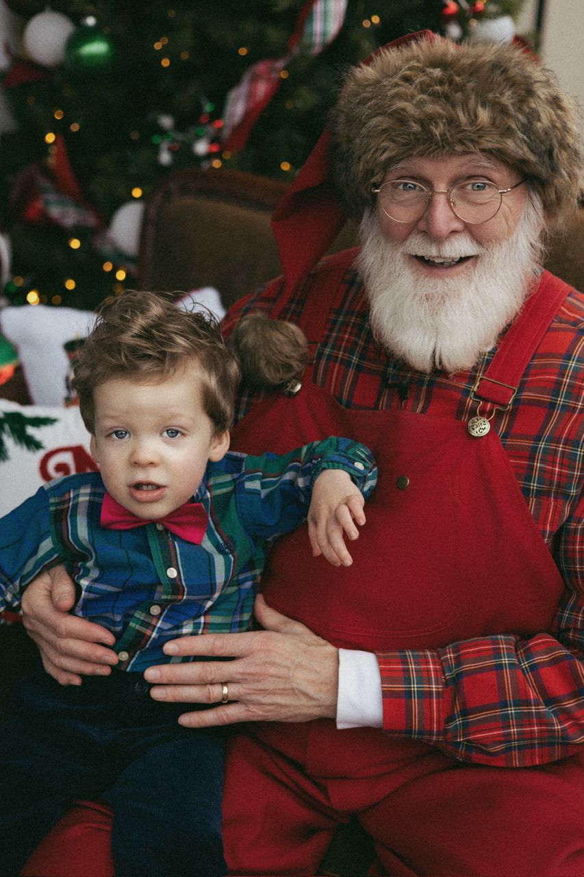 Holiday portrait with traditional Santa Claus in plaid and red attire.