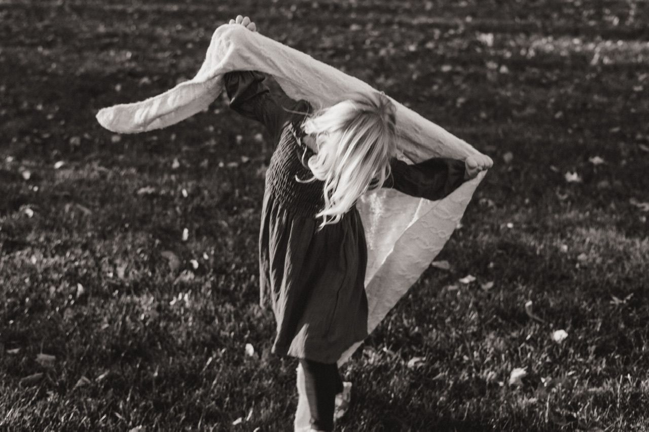 Black and white sequence of movement and play in a grassy field.