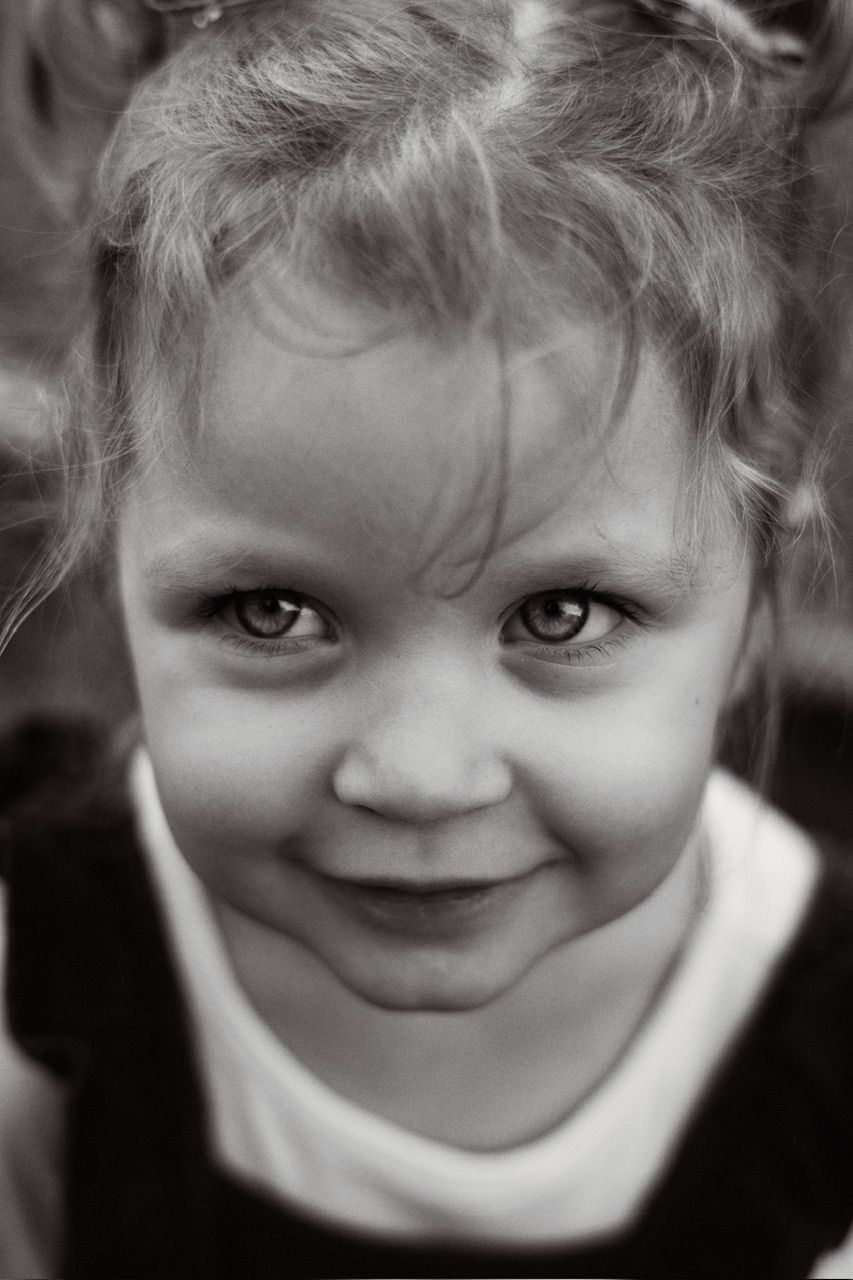 Black and white portrait sequence showing range of playful expressions and smiles.