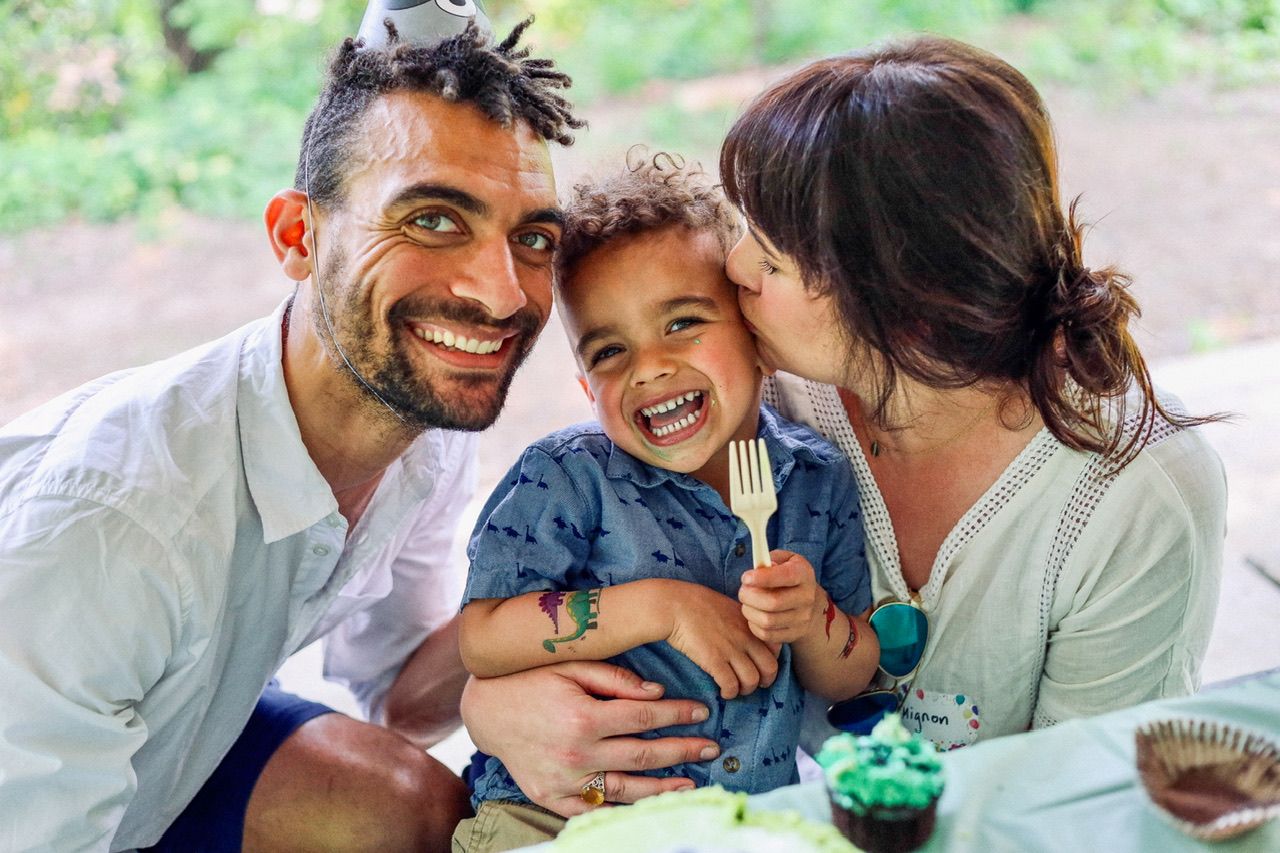 A family shares playful moments and laughter together indoors.
