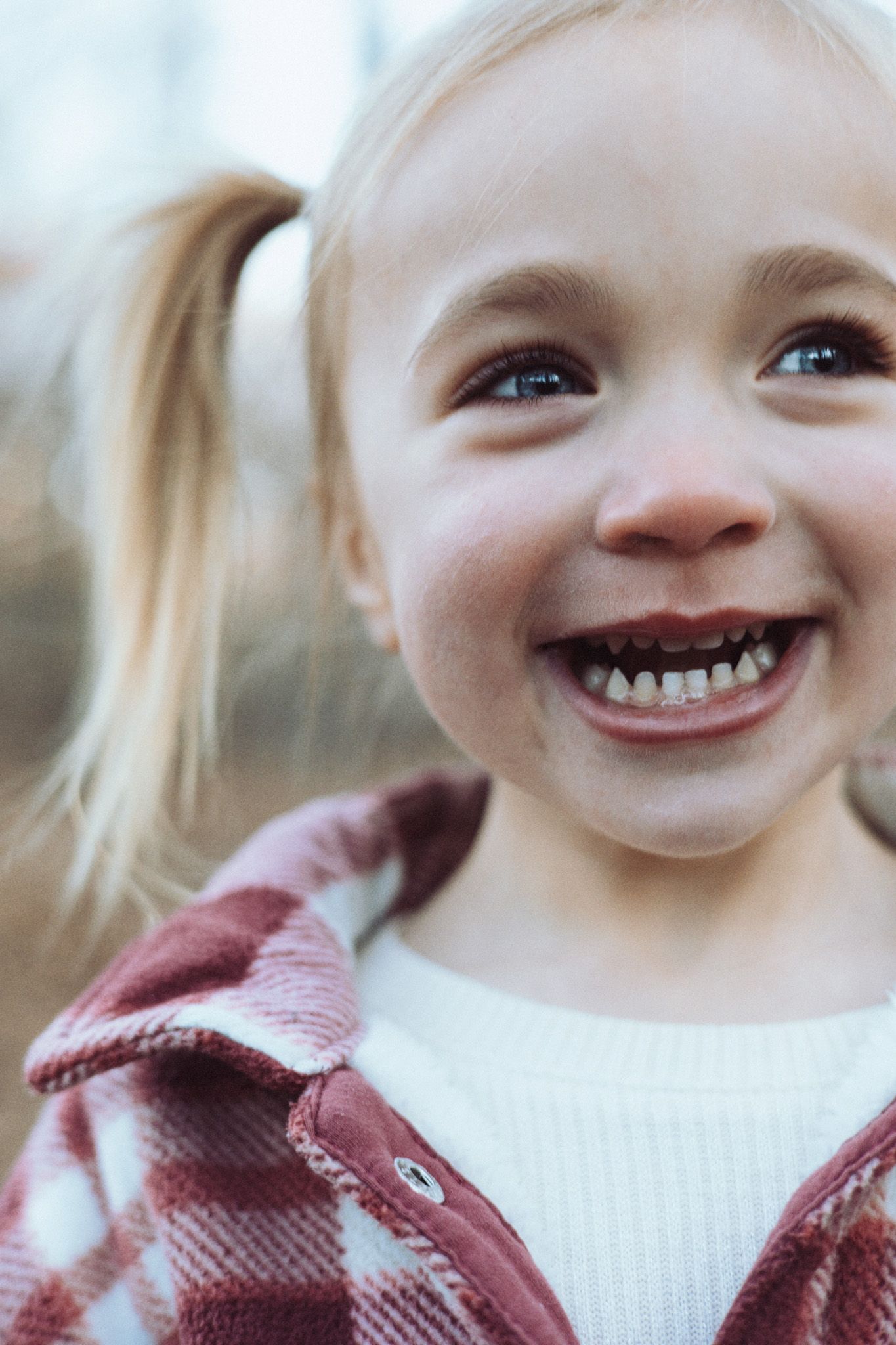 Close up portrait sequence showing joyful expressions and bright smiles in white sweater.