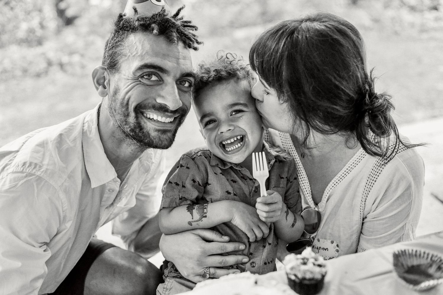 Black and white series showing joyful moments of family bonding outdoors.