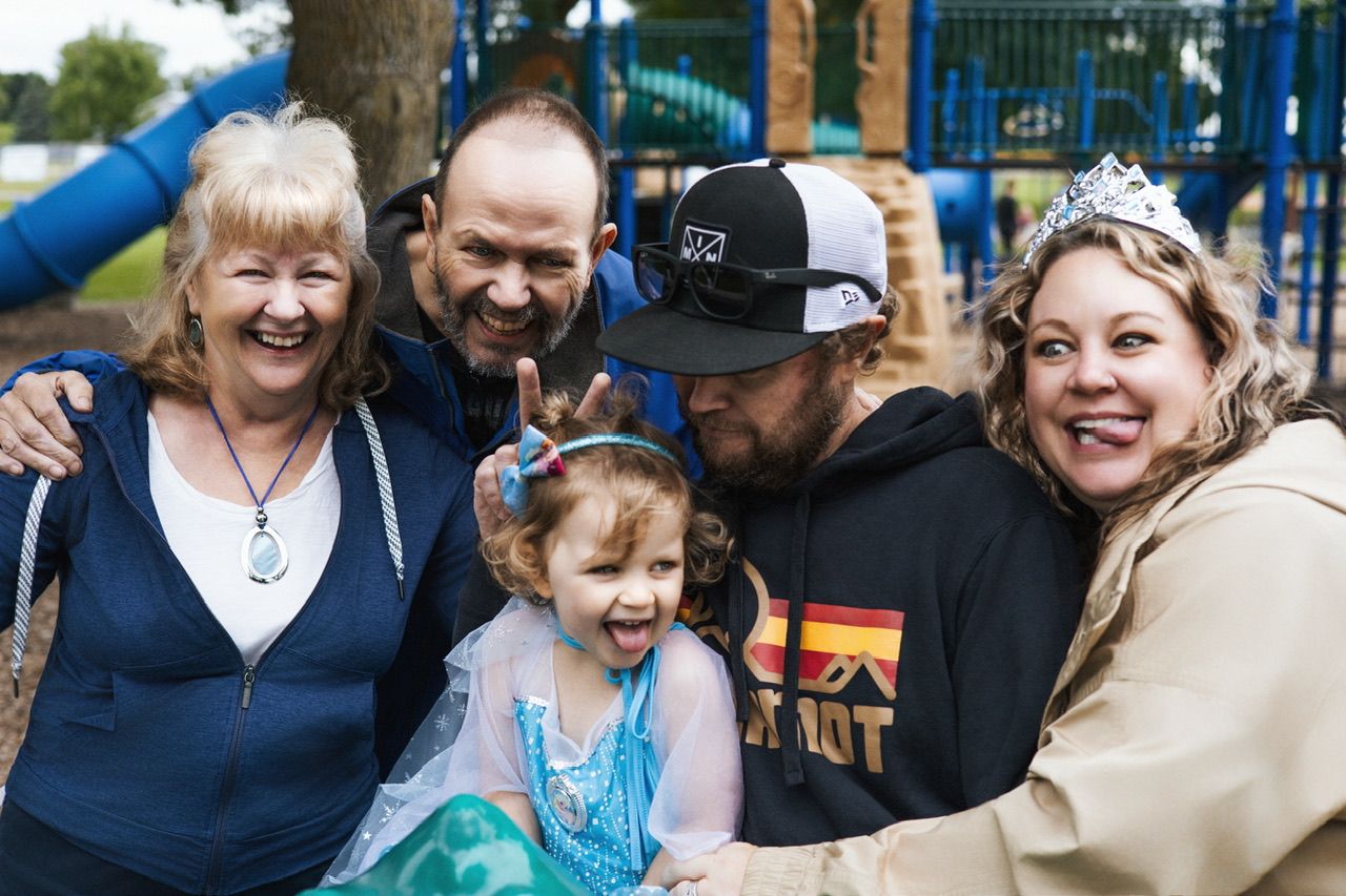 Happy family gathering at a playground sharing joyful laughter together.