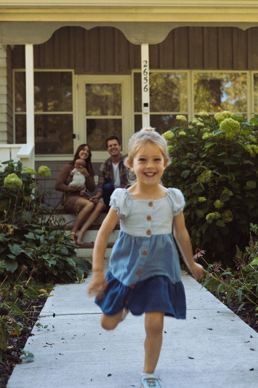 A sequence showing someone running and jumping along a white pathway in a blue dress.