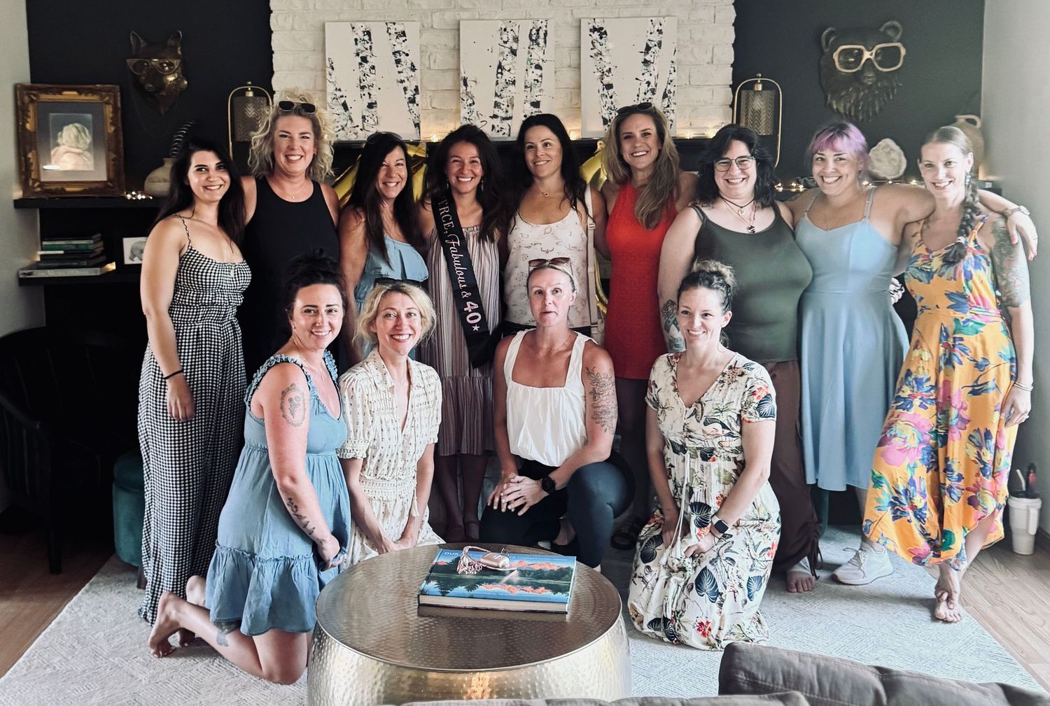 Group photo of friends gathered together for a celebration in casual summer dresses.