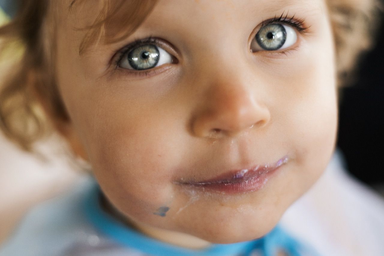 Extreme close-up portrait highlighting bright eyes and gentle expression.