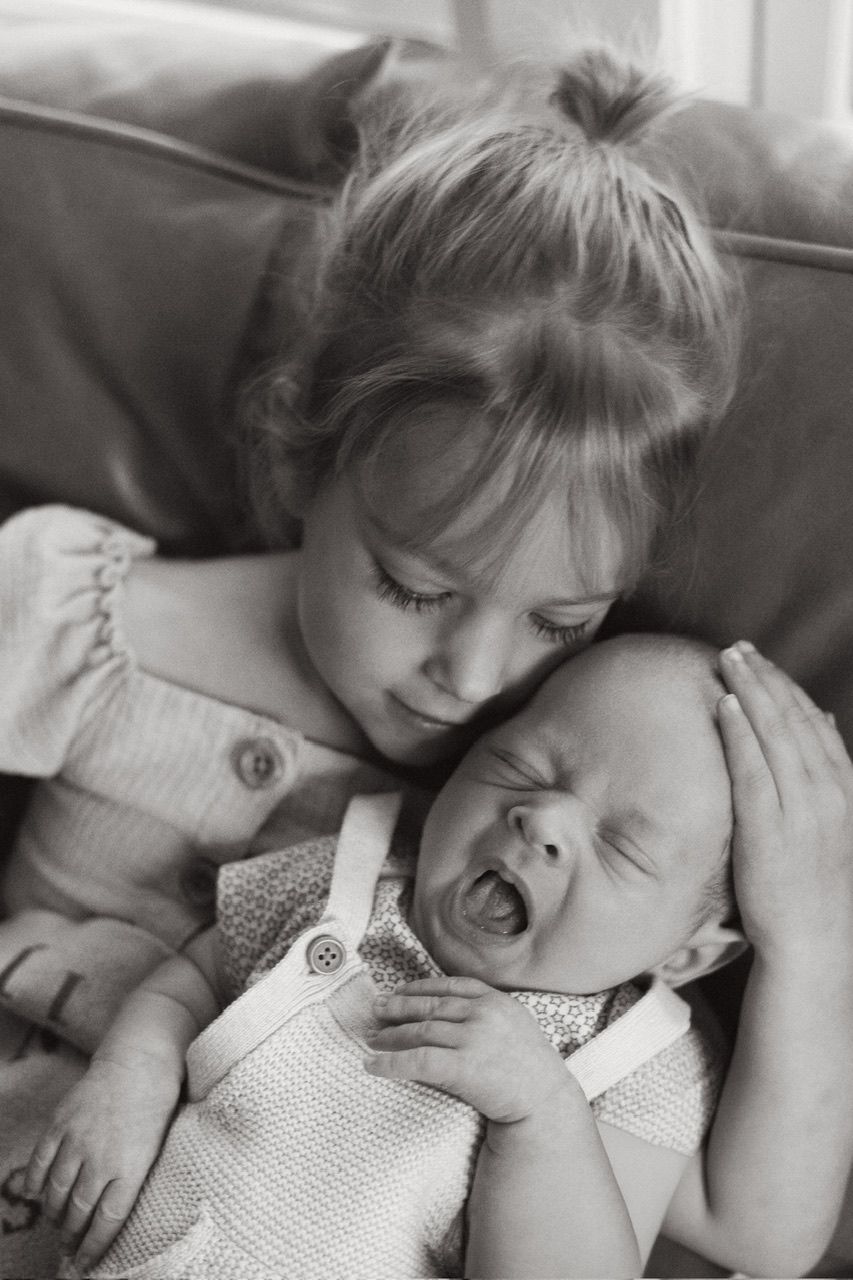 Two people sharing a tender moment while resting on a couch.