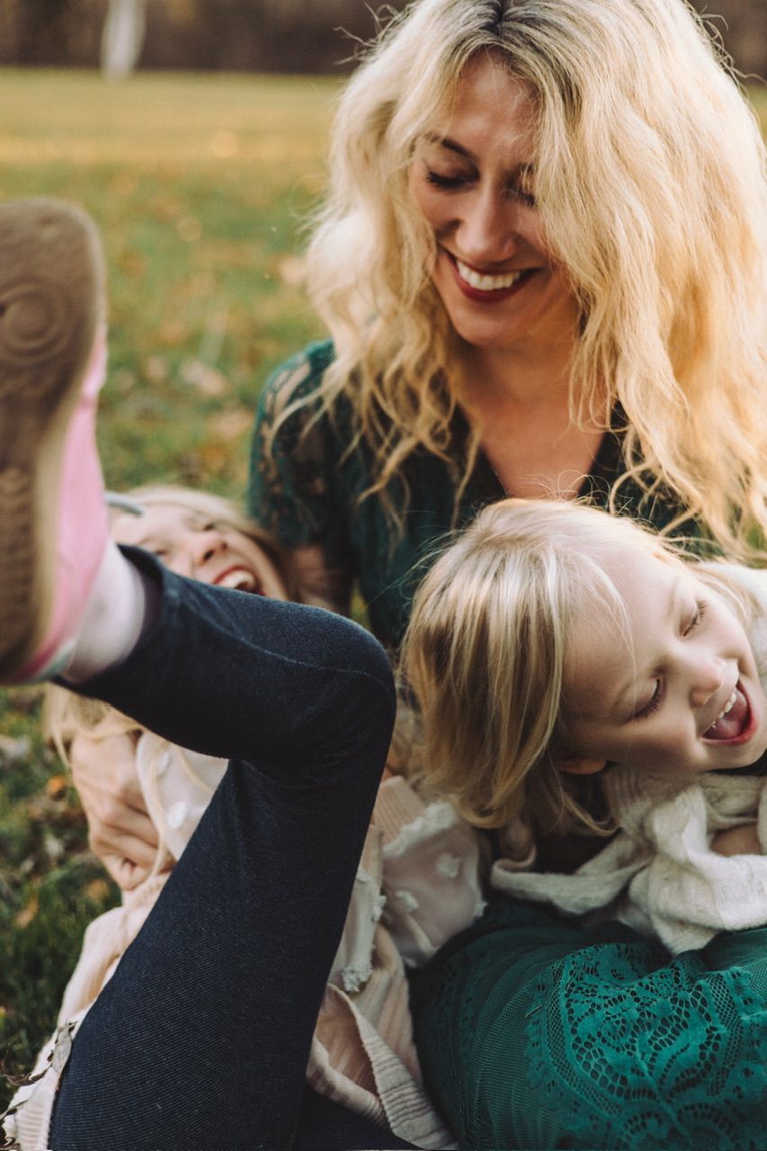 A joyful family moment captured in a series of candid photos showing playful interaction in emerald green attire.