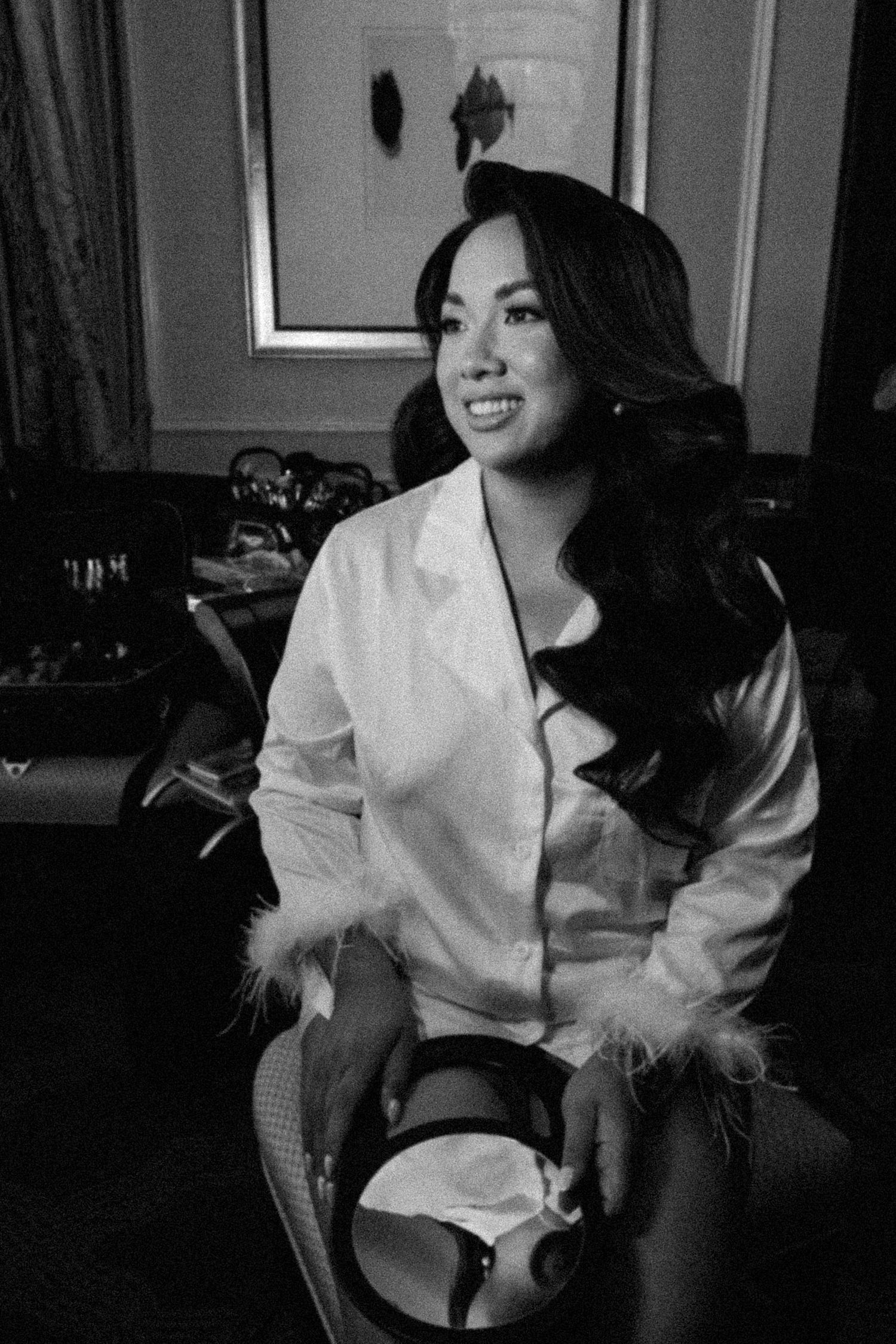Black and white portrait series showing relaxed moments in a white button-down shirt.