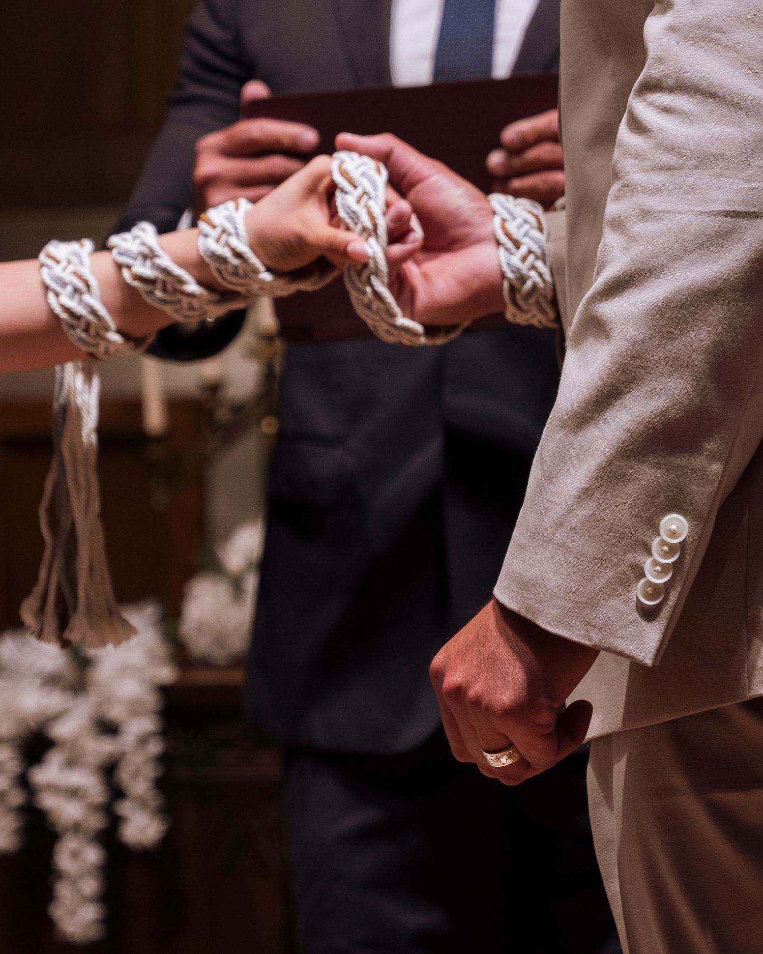 Close-up of hands exchanging wedding rings during an intimate ceremony.