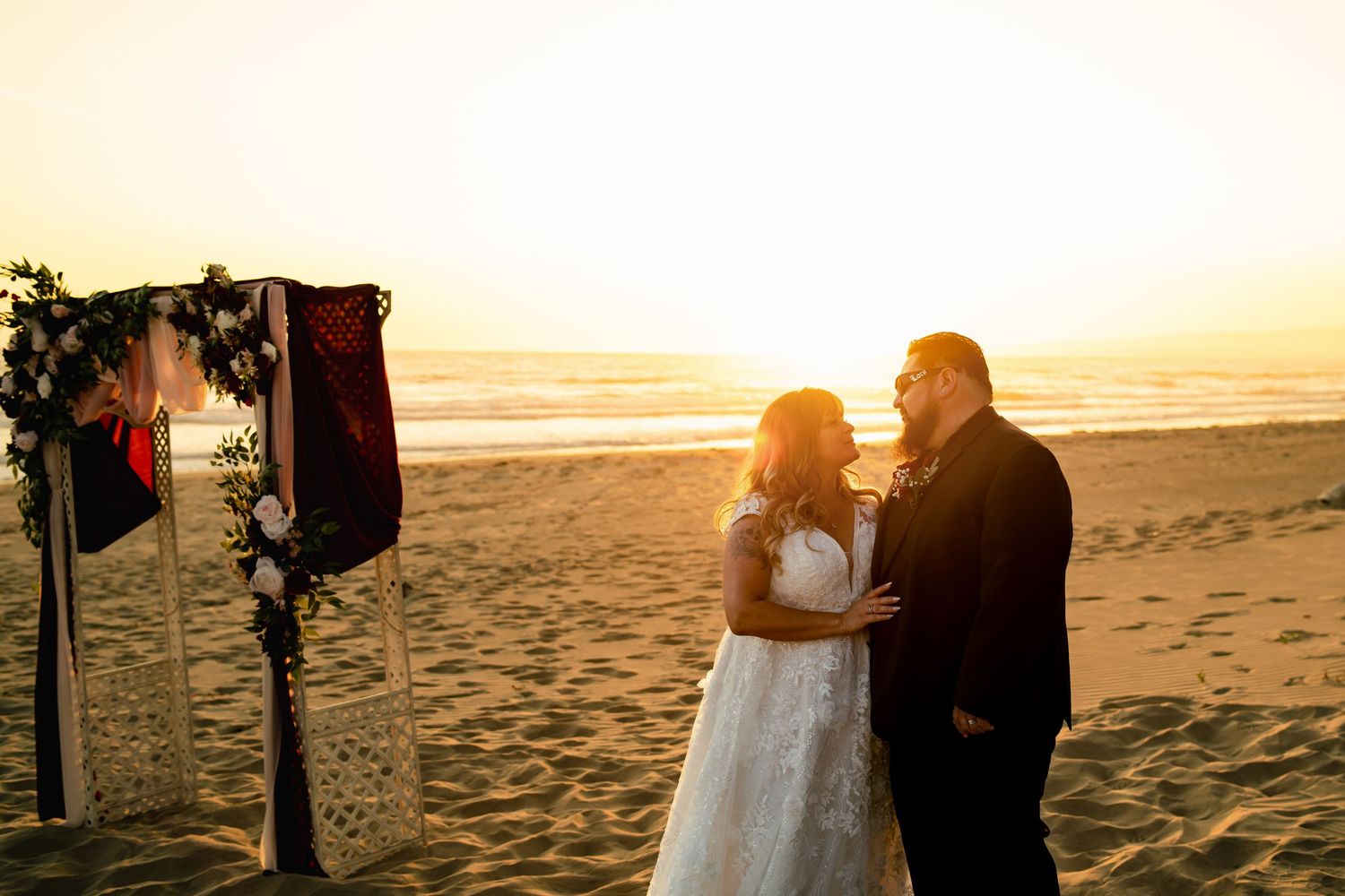 Wedding ceremony moments captured during golden hour on a sandy beach.