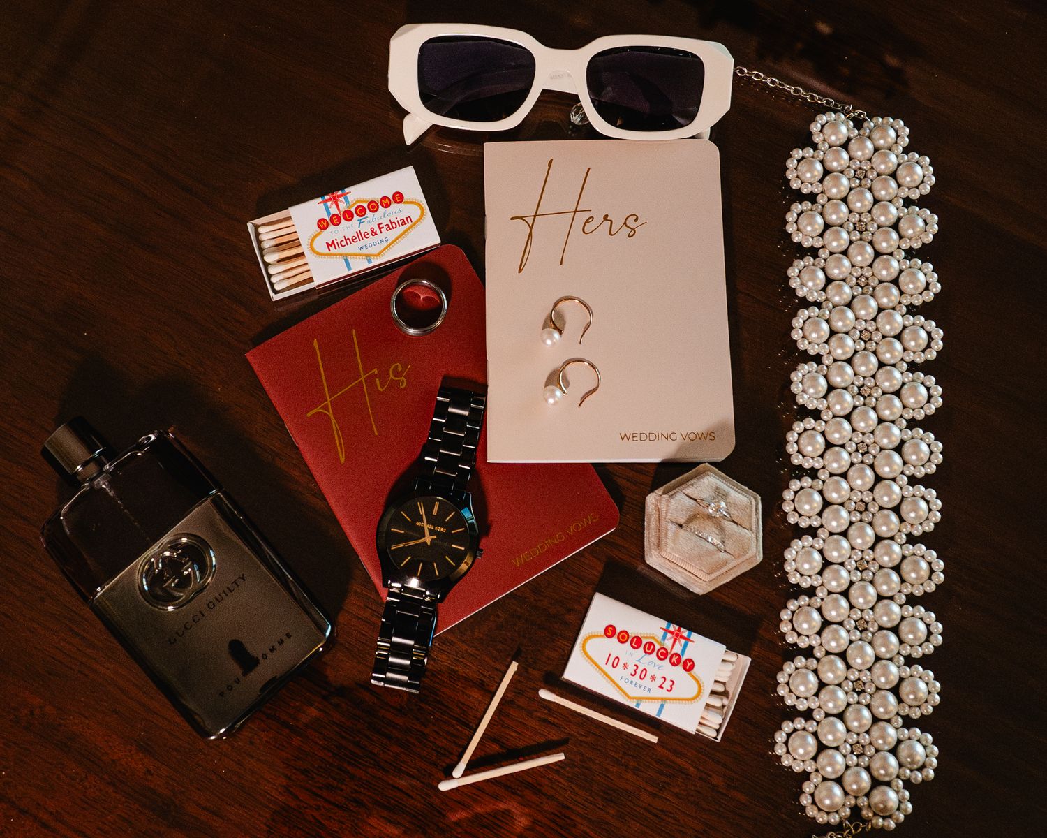 A series of vintage accessories including sunglasses, lace trim, and antique items arranged on a dark wooden surface.